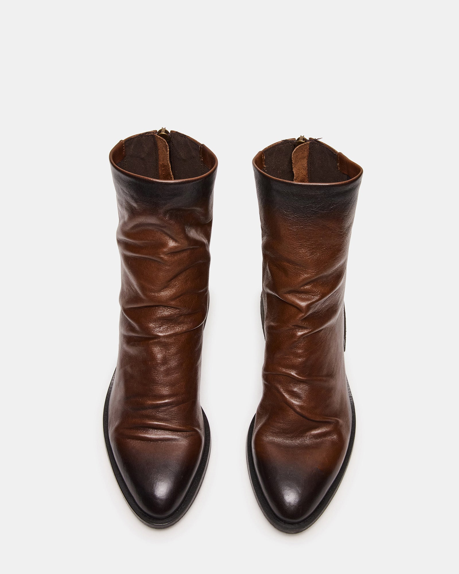 Side view of brown ankle boots with pointed toe and zip closure