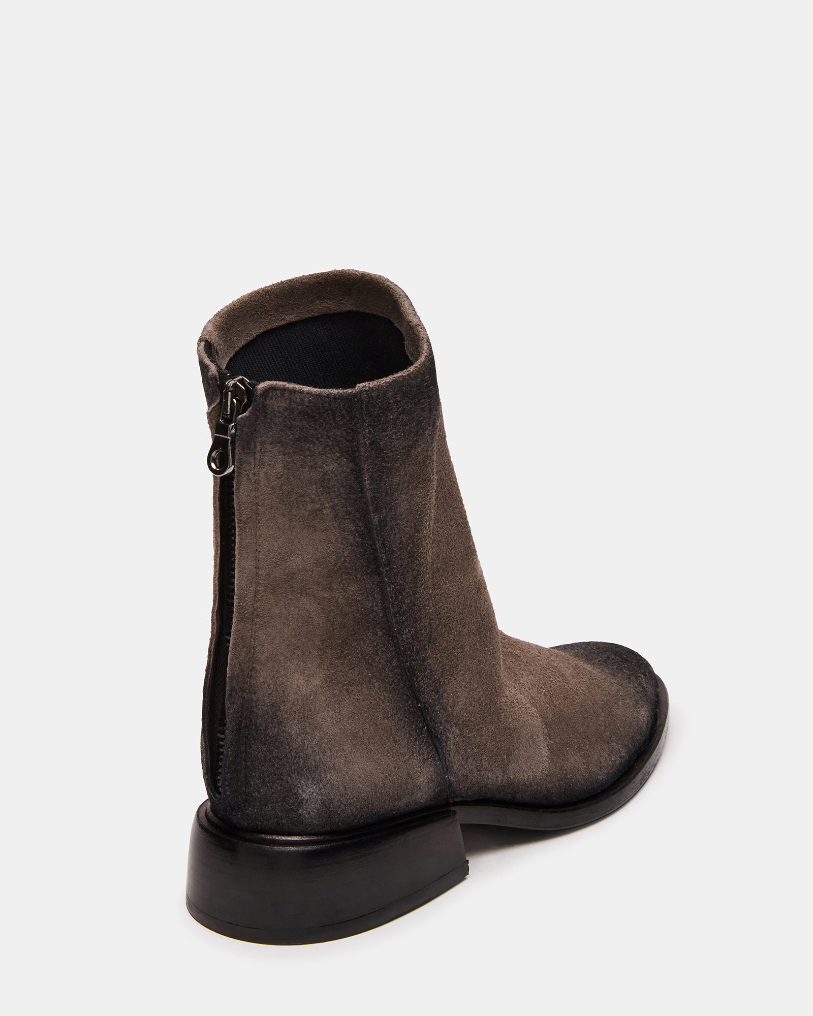 Side view of stylish grey suede boots featuring a sleek silhouette and easy access zip