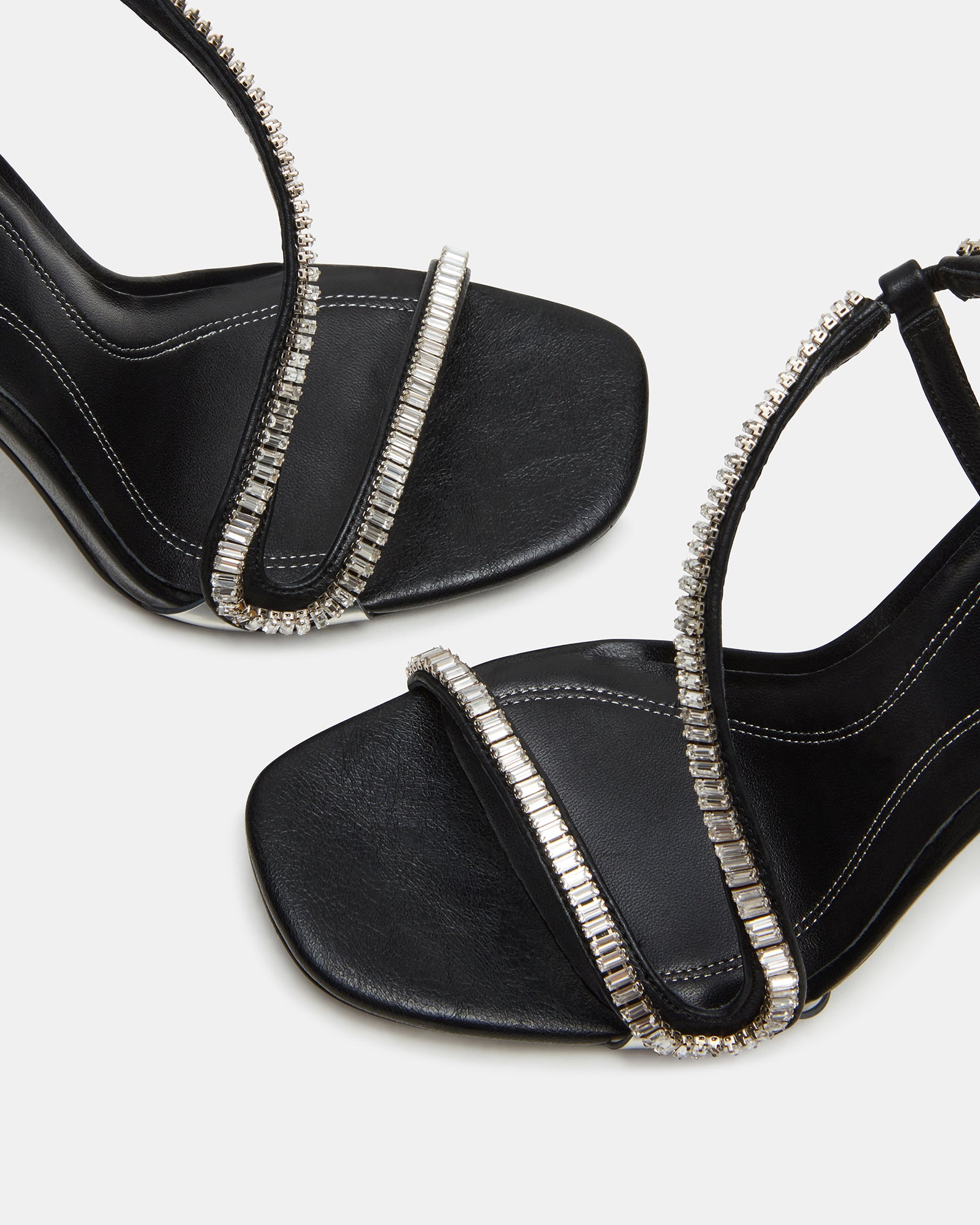 Side view of nude strappy heels showcasing rhinestone details.