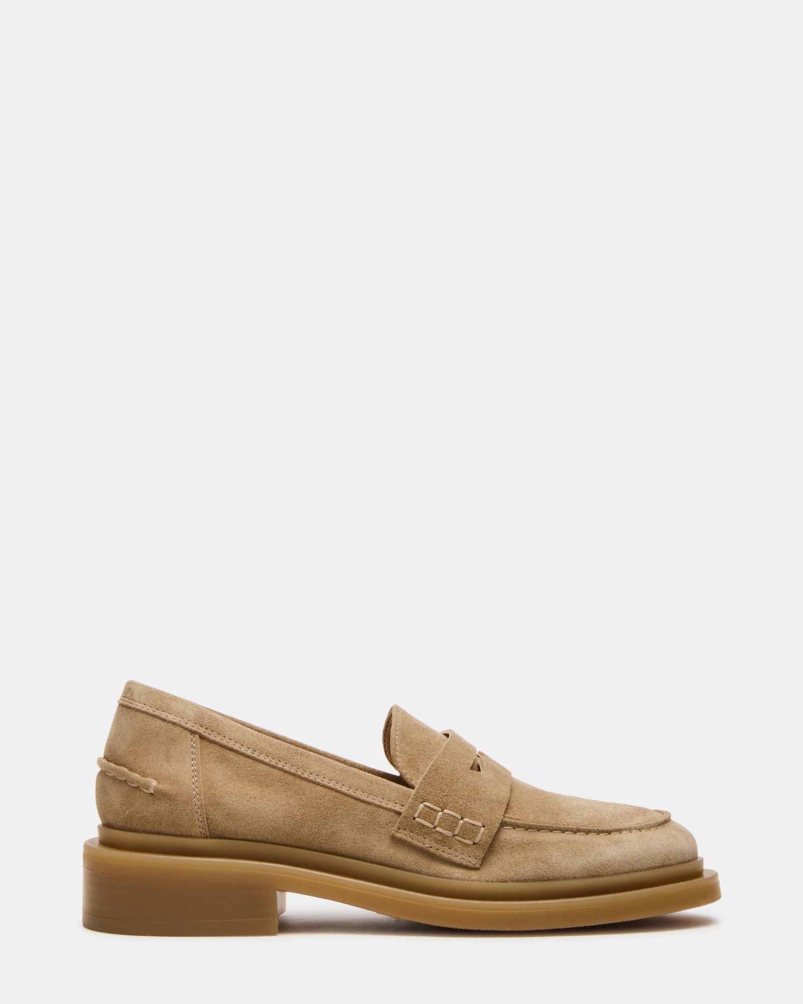 Men's taupe suede loafers with rounded toe and slip-on style on a wooden floor