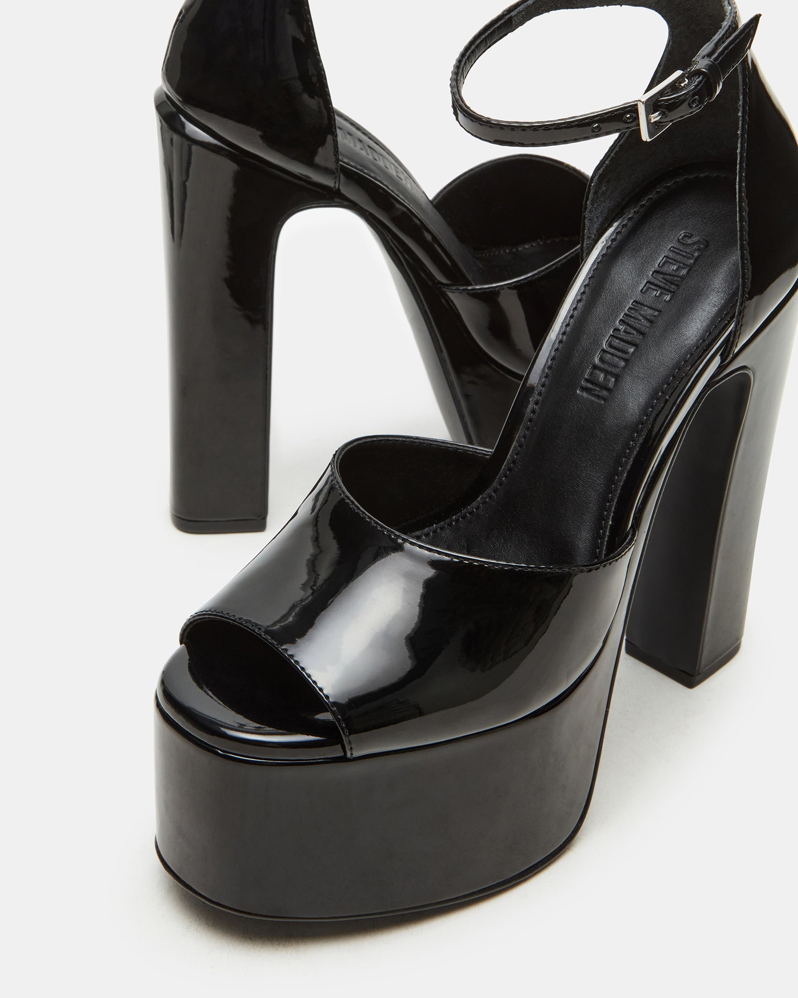 Close-up of the ankle strap and heel details on Nightfall black platform shoes