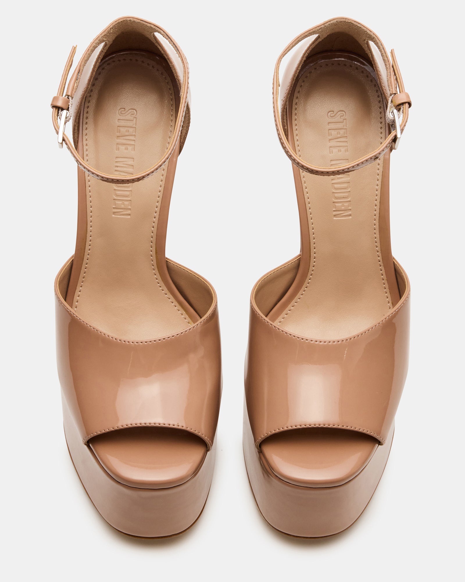 Side view of blush heels with block platform on wood floor