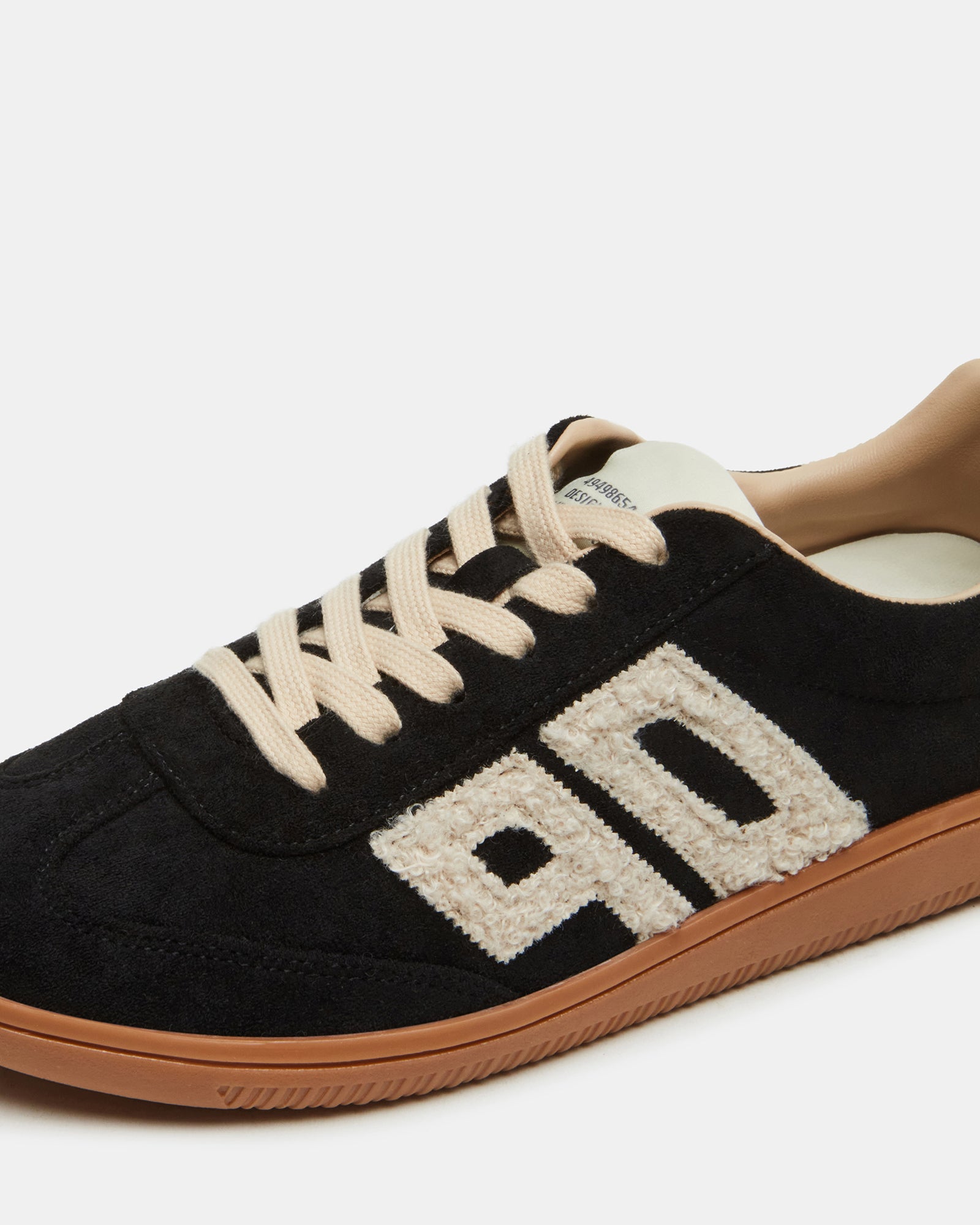 Low top sneakers styled with casual wear for a relaxed look.