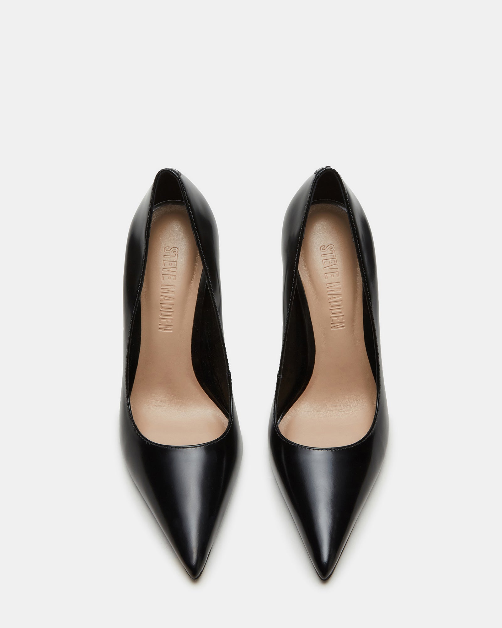 Side view of black leather pumps highlighting the pointed toe design