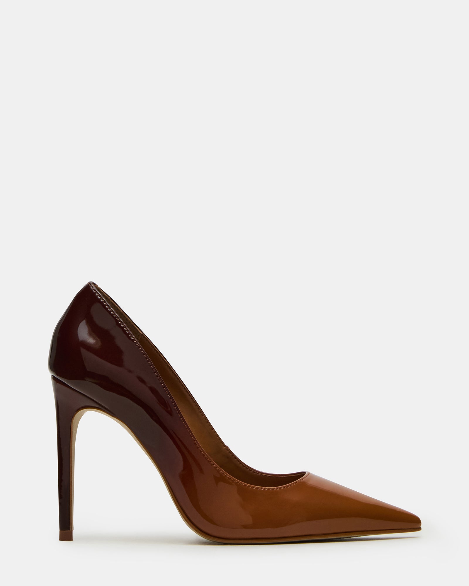 Angled close-up of black pointed toe heels on hardwood flooring