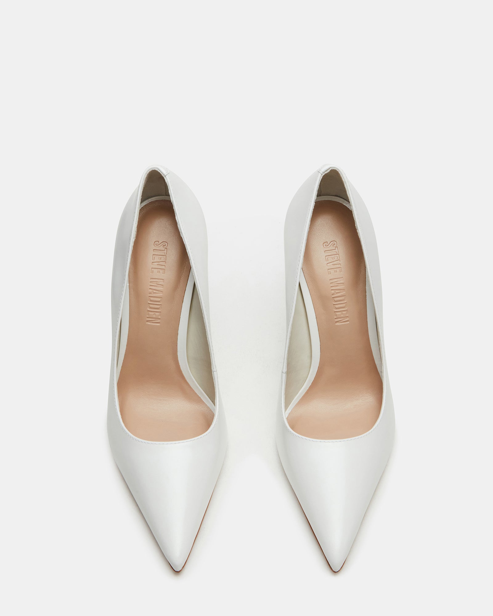 Close-up of white patent leather pumps highlighting luxurious texture.