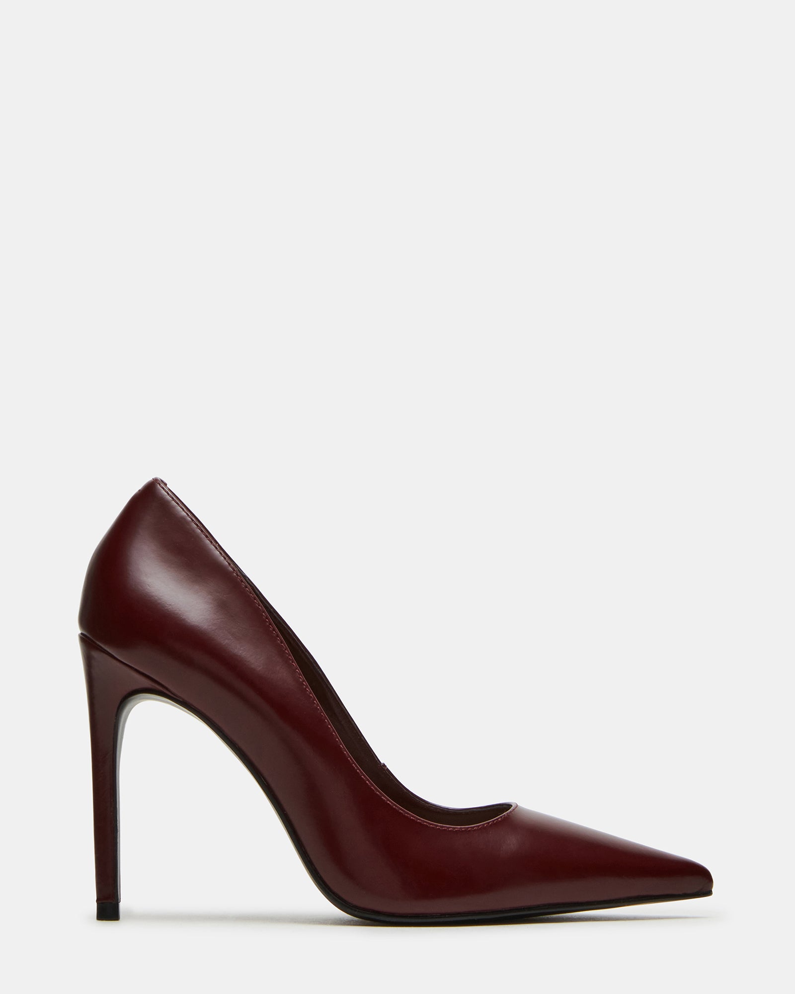 Close-up of black pointed toe shoes with stiletto heels on a stylish model