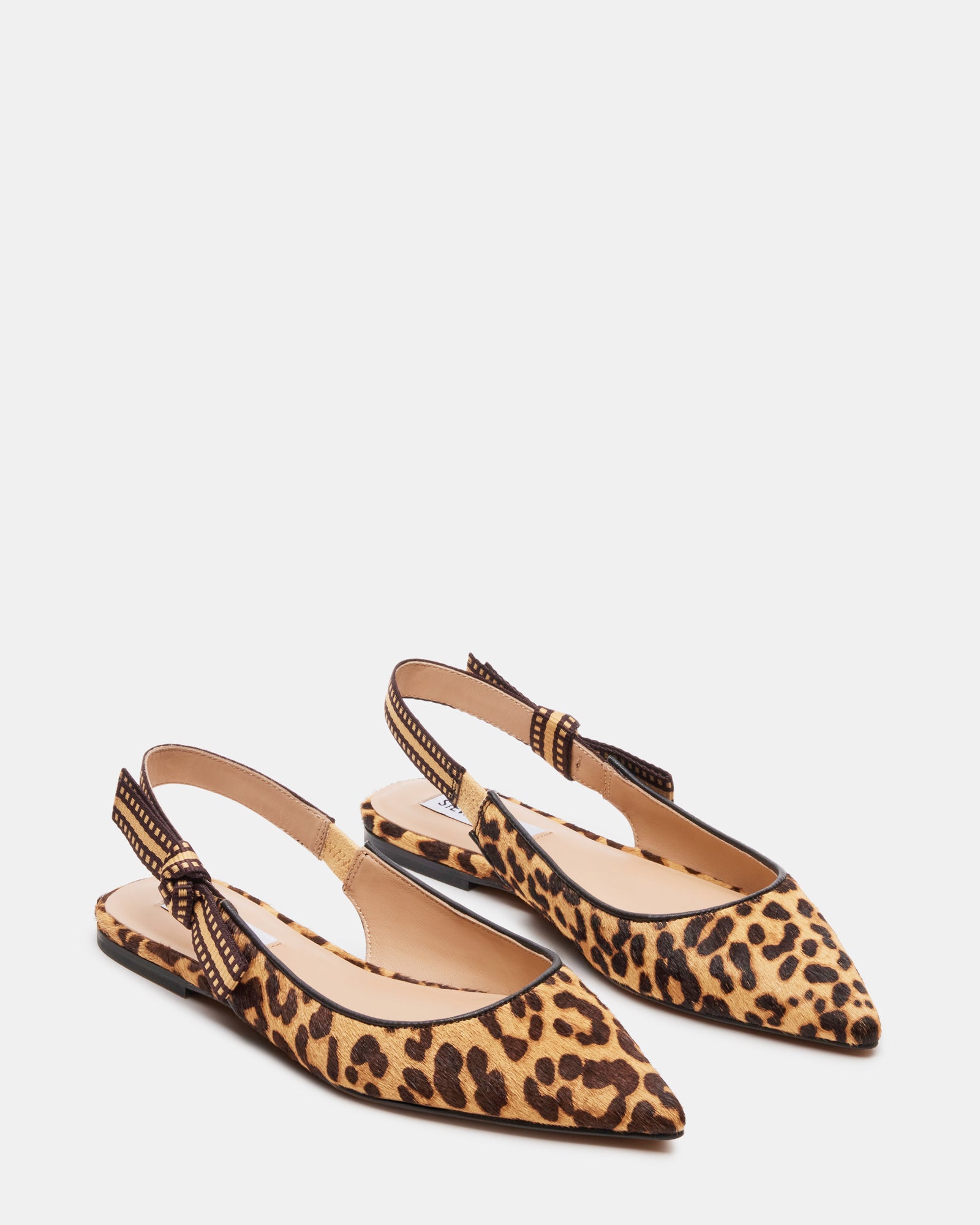 Olsen ballet flats worn with a stylish outfit in an urban setting.