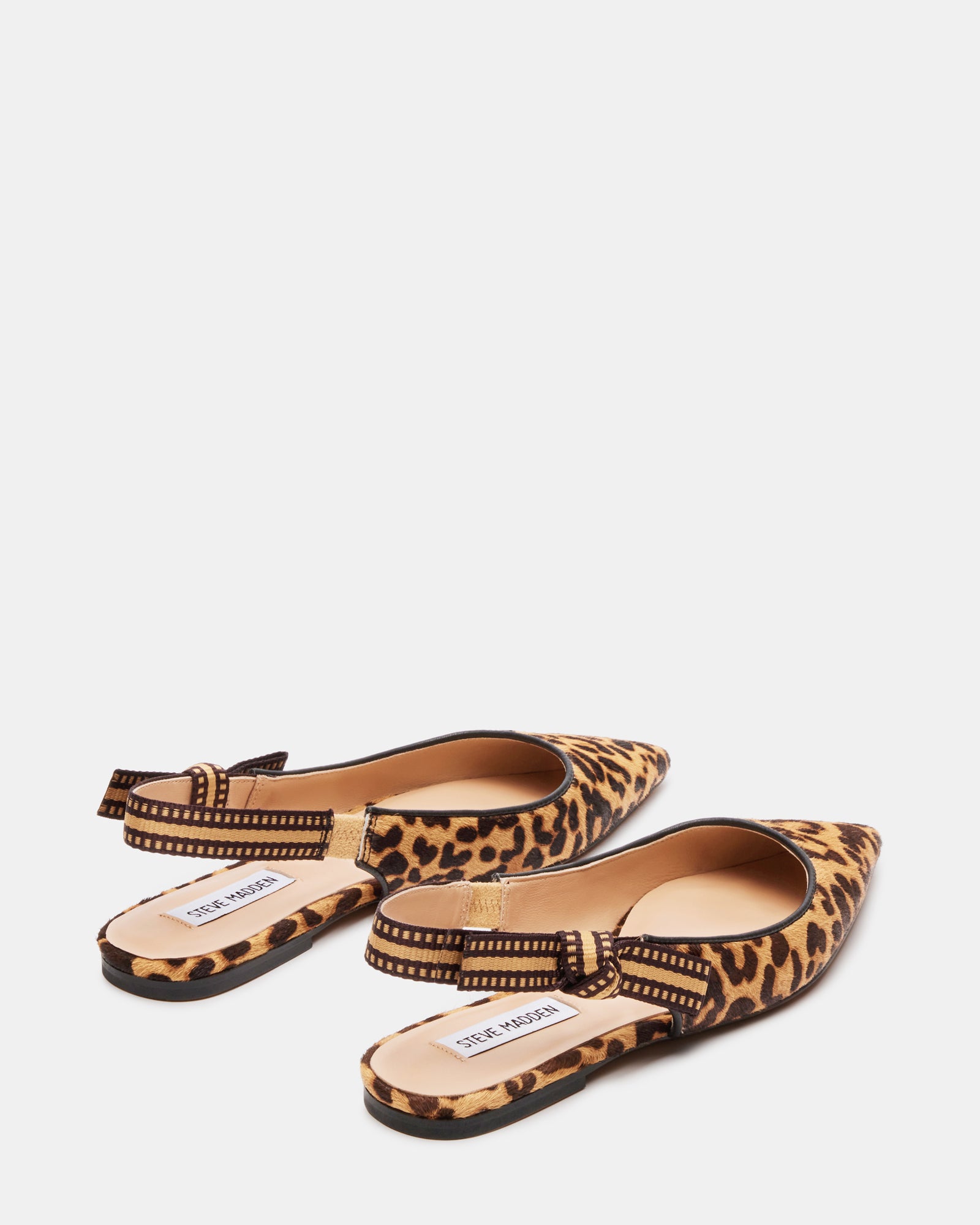 Olsen ballet flats worn with a stylish outfit in an urban setting.