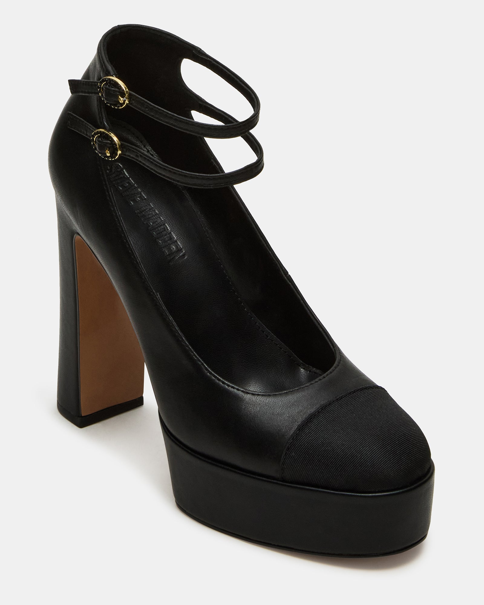 Peyton block heel sandals worn with a chic outfit, perfect for a night out.