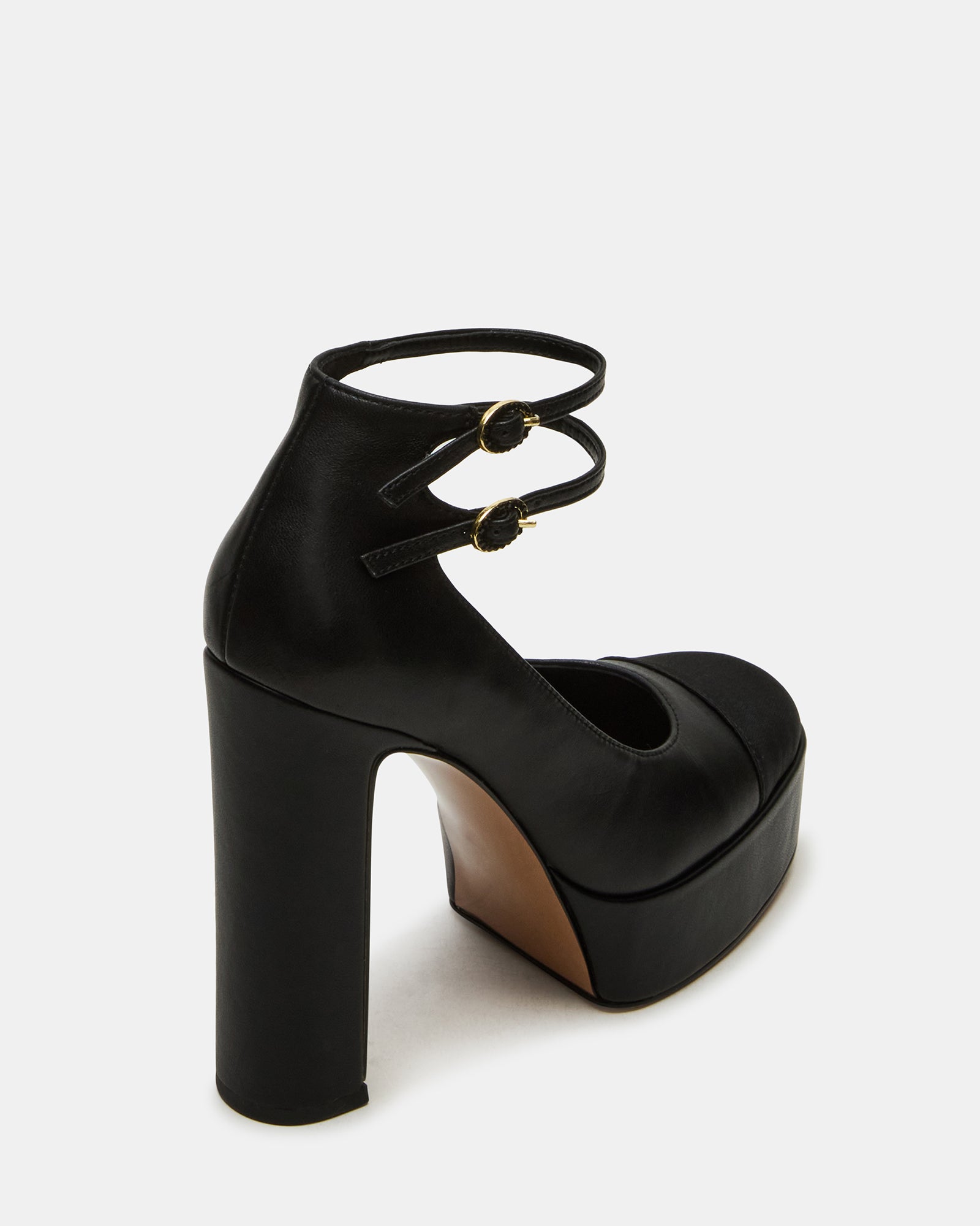 Peyton block heel sandals worn with a chic outfit, perfect for a night out.