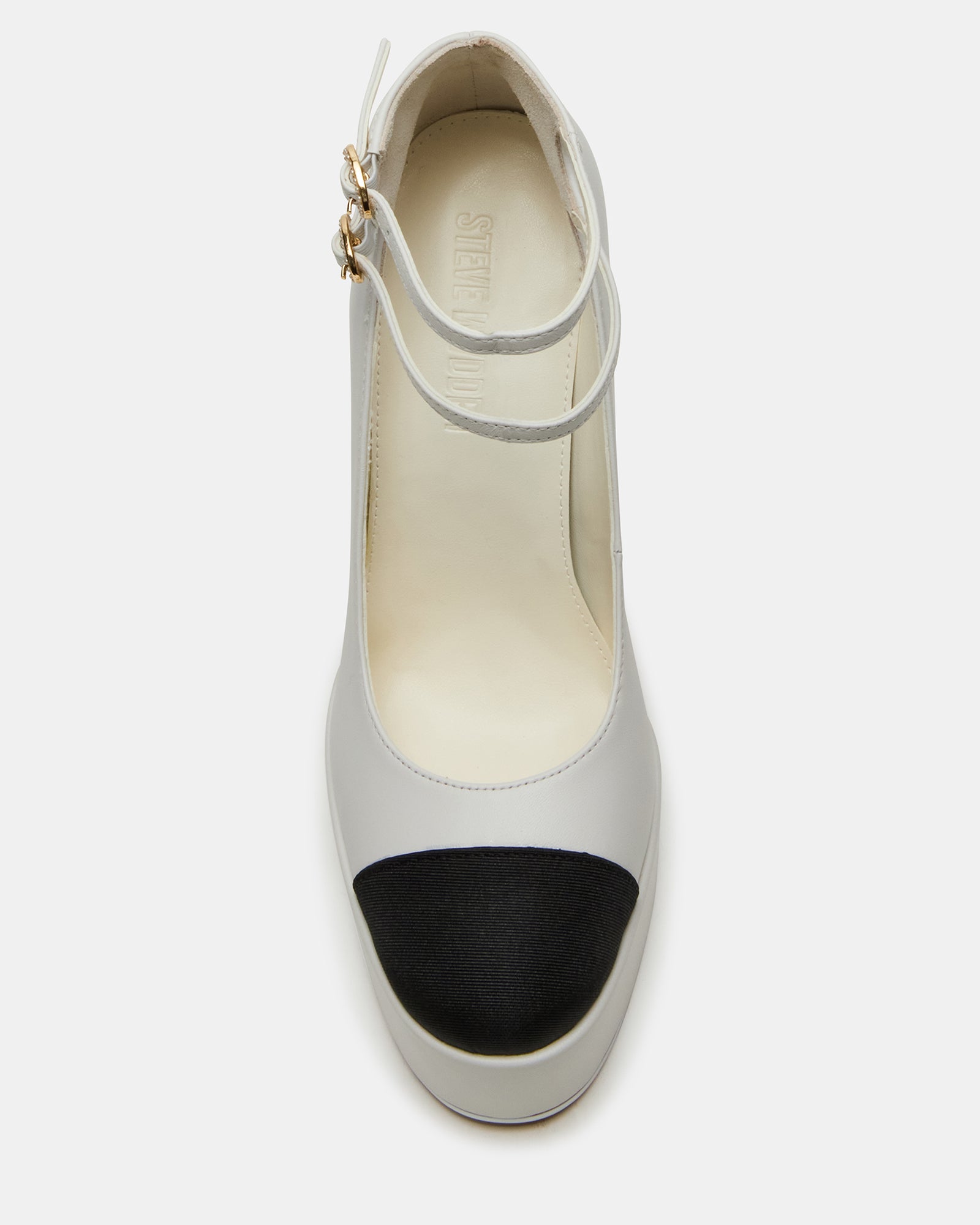Close-up of white leather heels showing toe cap detail and textured upper