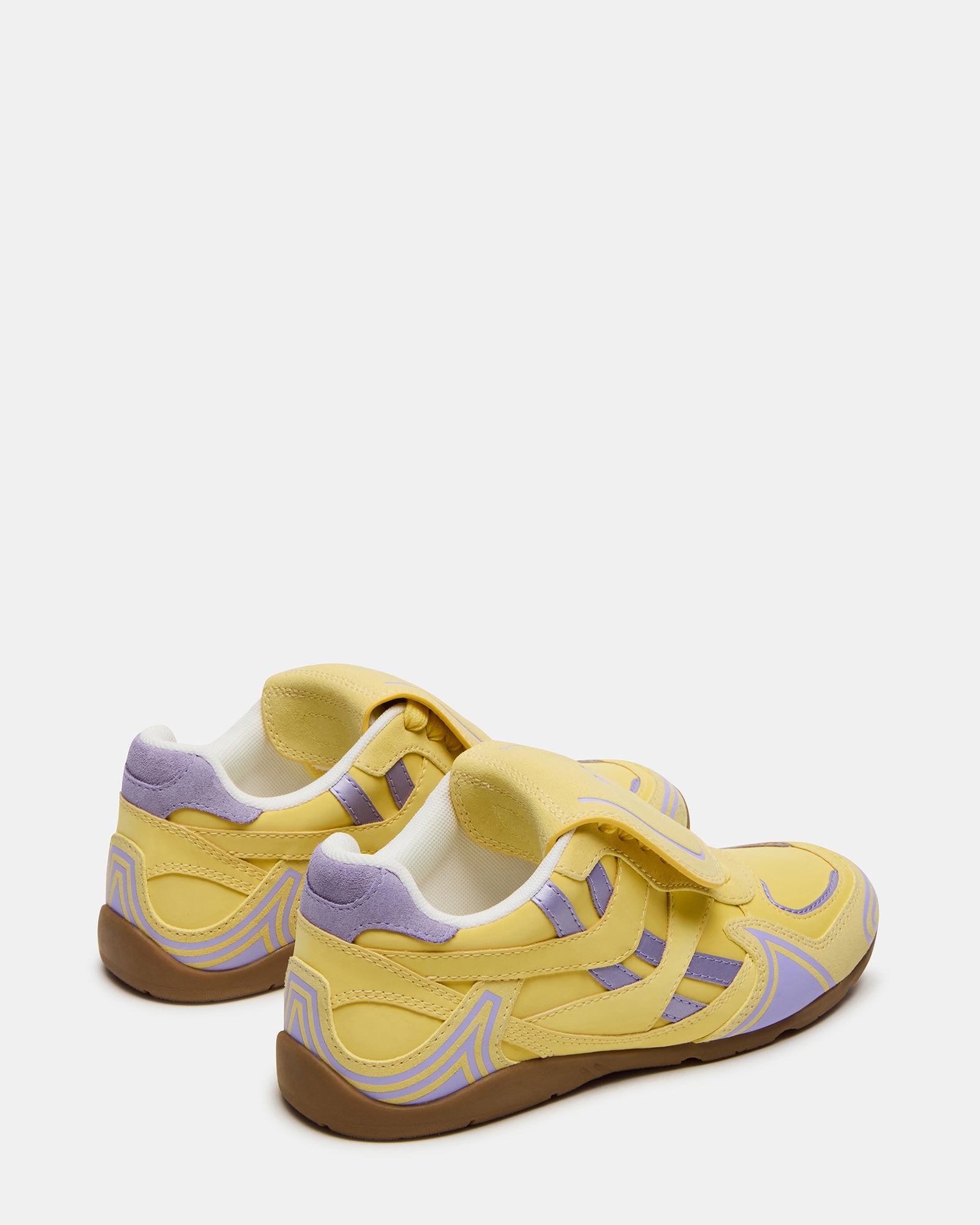 Side view of the sneakers showcasing the suede and textile upper.