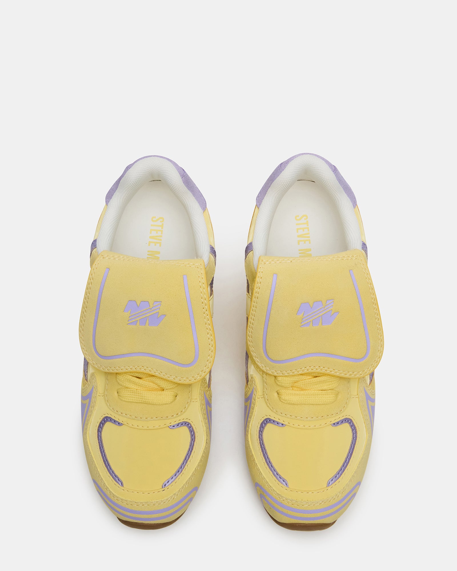 Optimus Yellow Multi sneakers paired with jeans for a casual look.