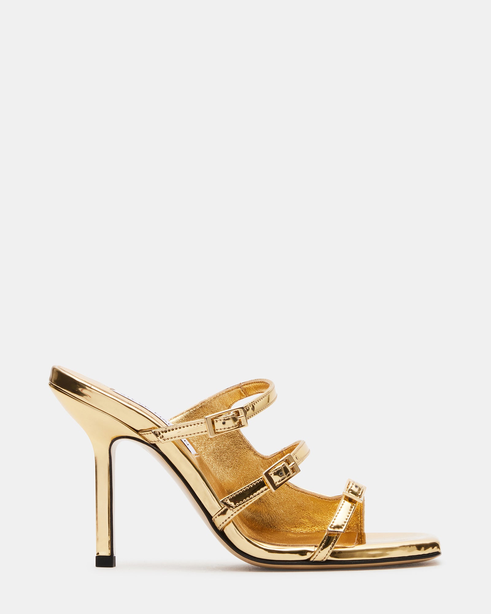 Close-up of gold platform heels with square toe and strappy design