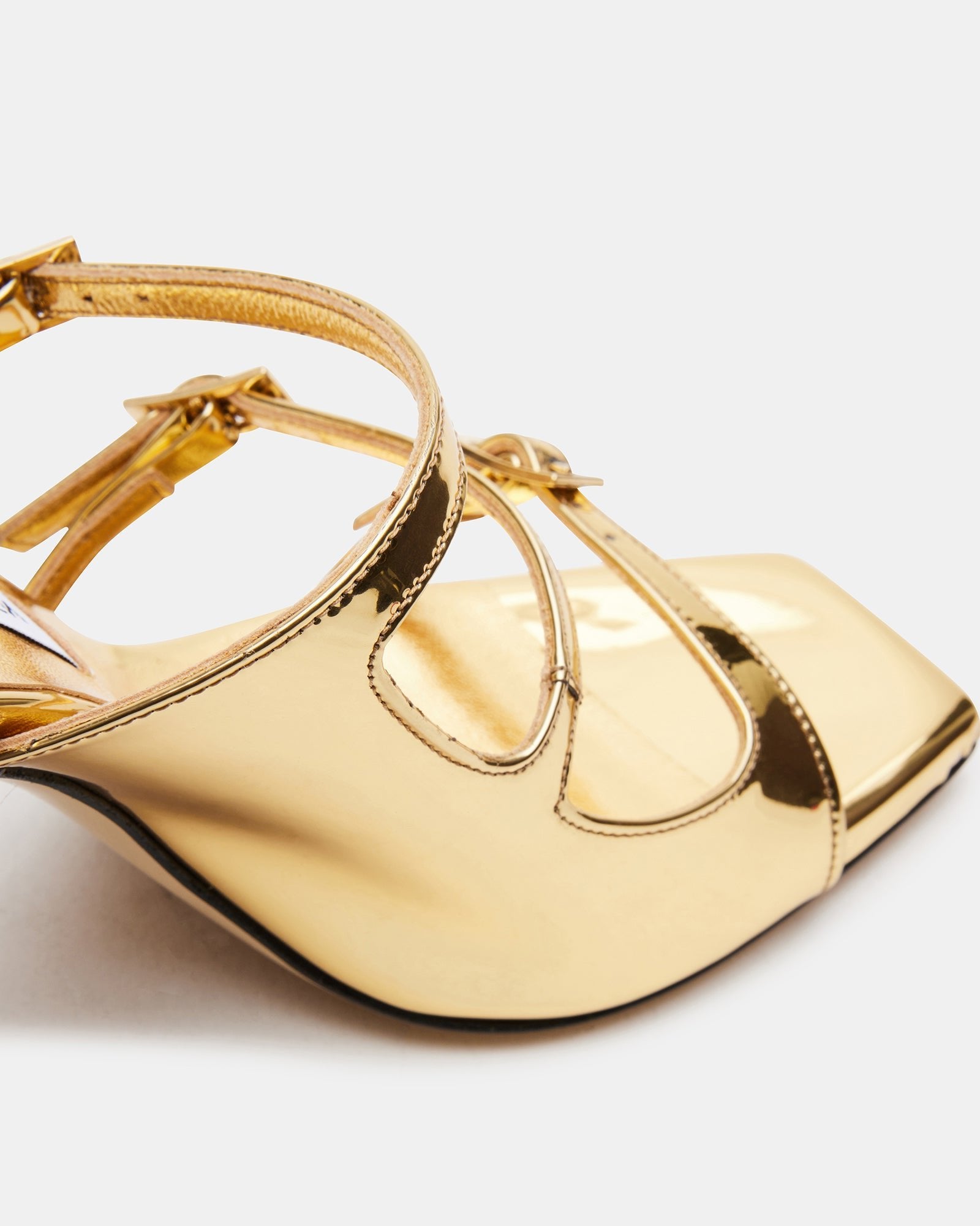 Side view of gold heels showing the elegant heel height and leather finish
