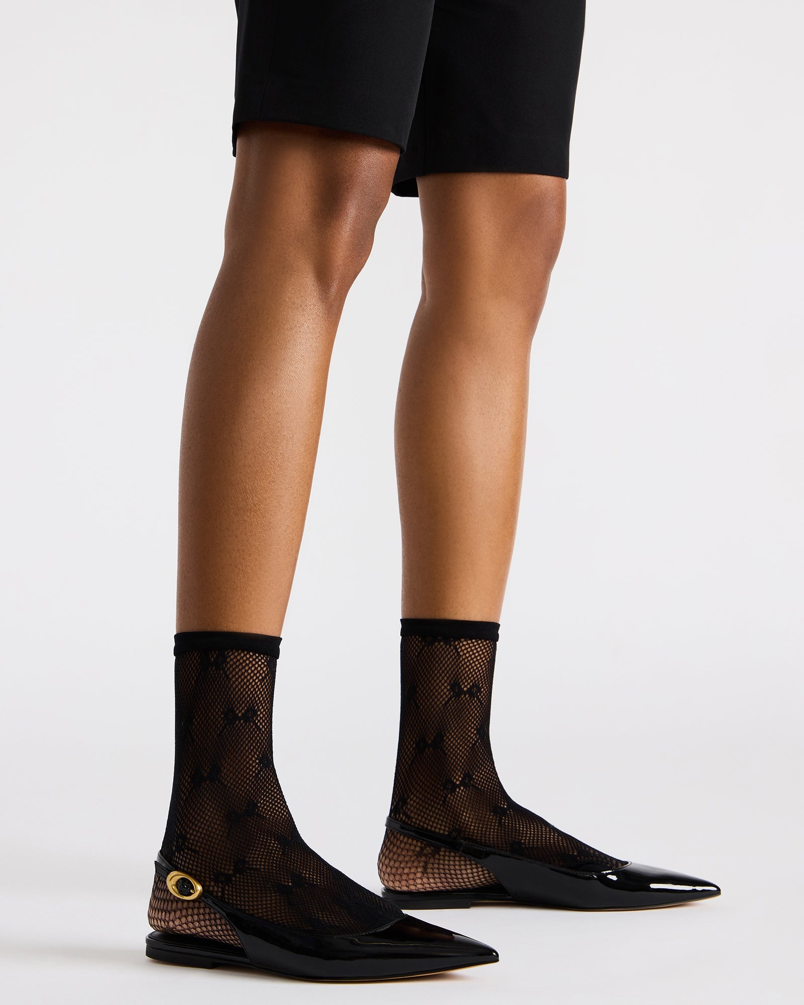 Close-up of pointed toe design on stylish slingback flats.
