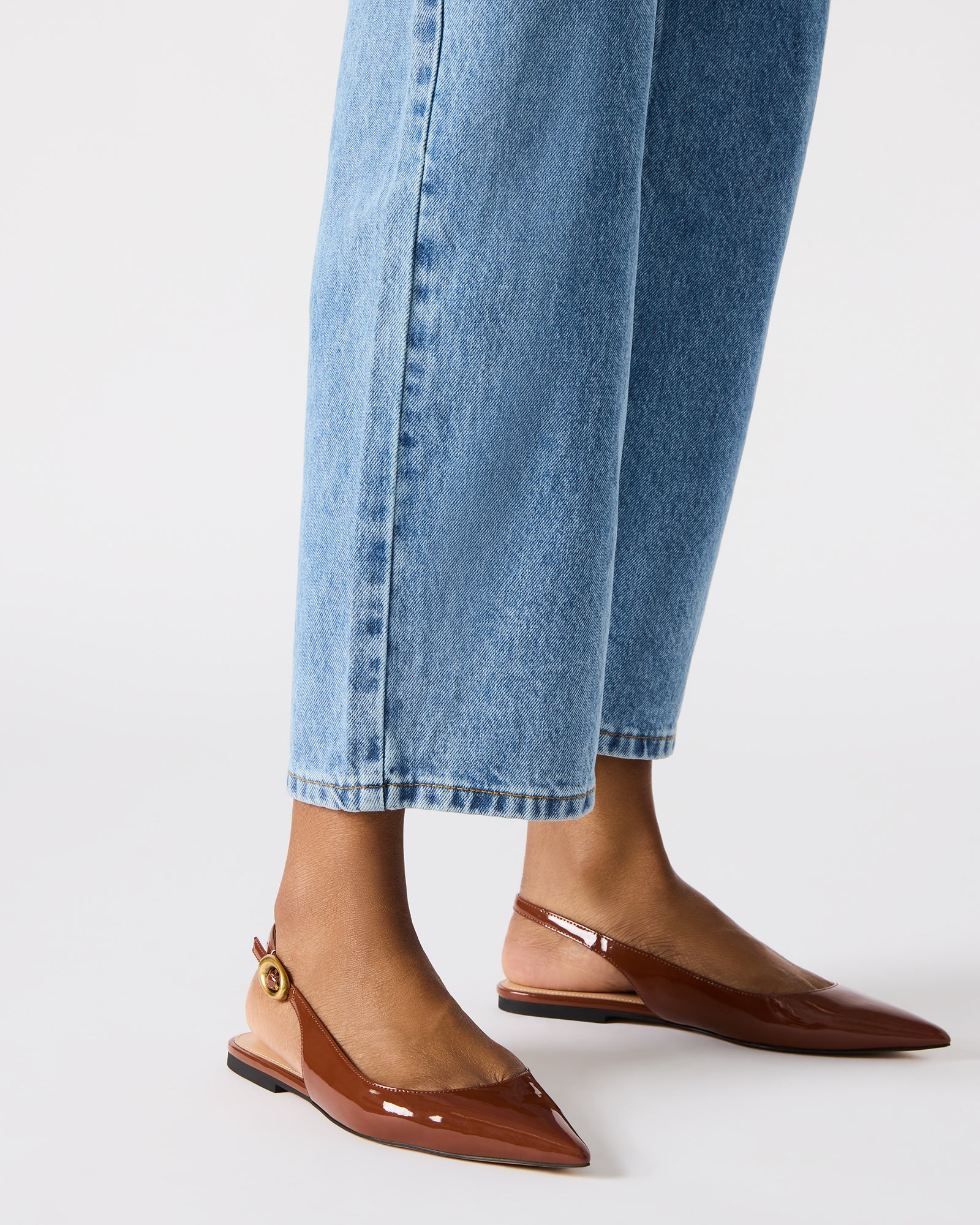 Woman wearing slingback flats with jeans walking urban streets