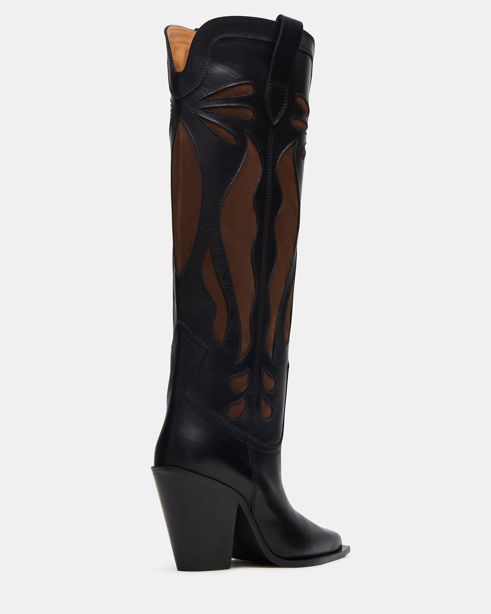 Brown knee high boots paired with jeans for everyday wear