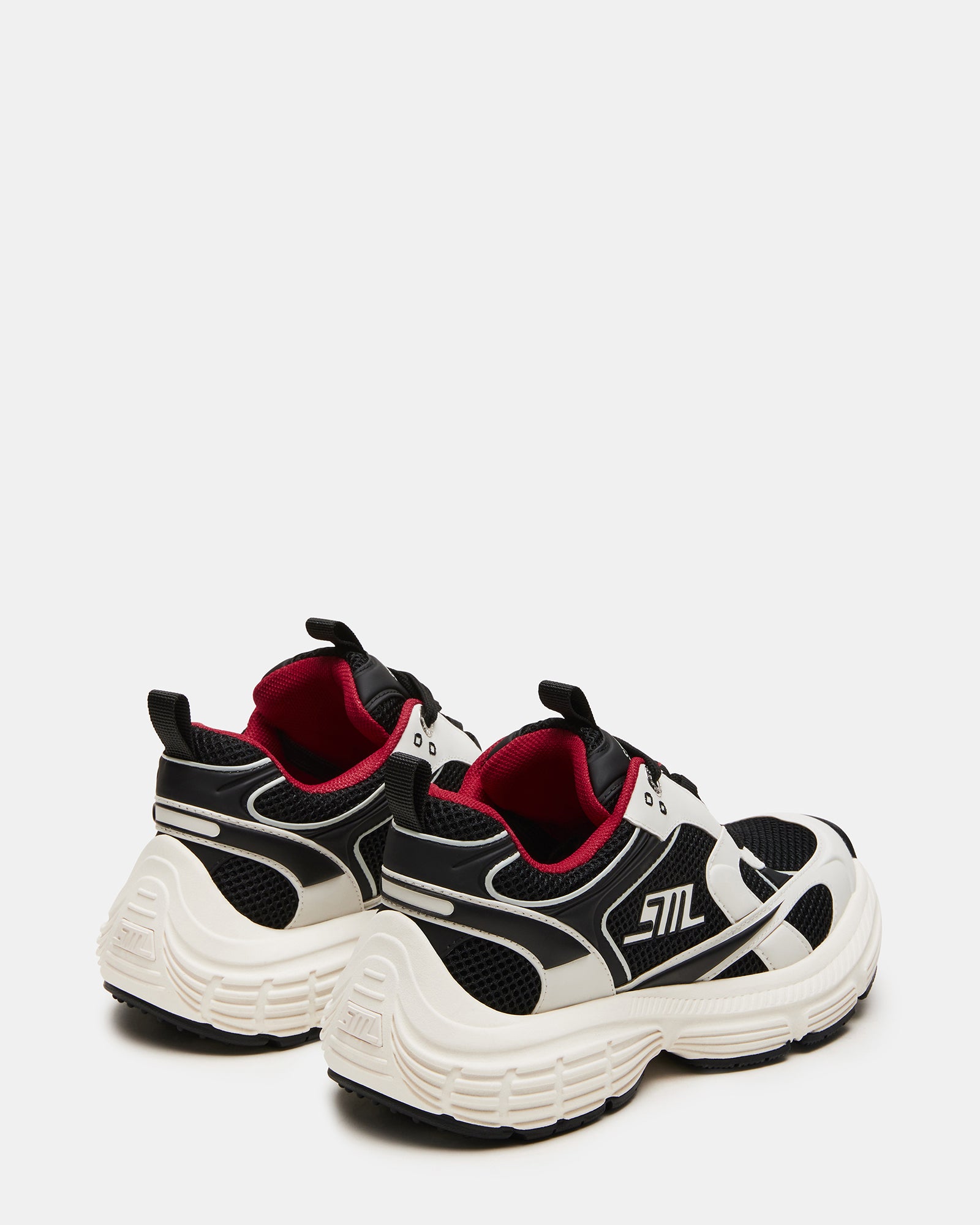 Side view showing textile material and synthetic sole on womens black sneakers.