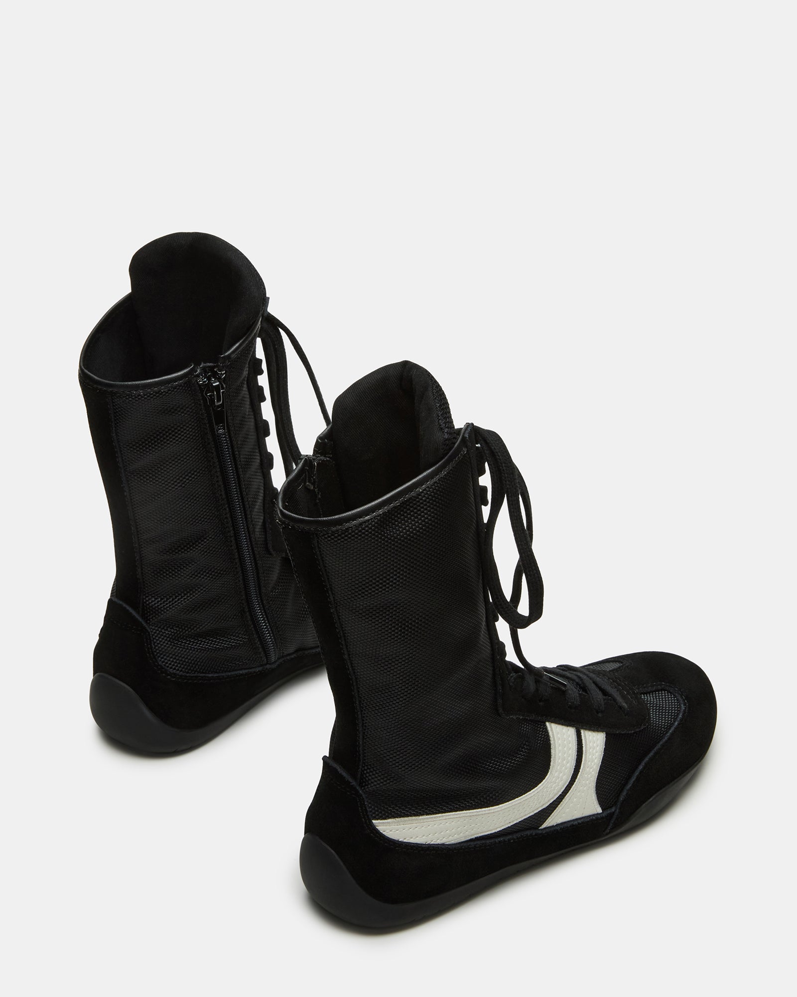 Side profile of lace-up sneakers showing the layered suede and textile upper