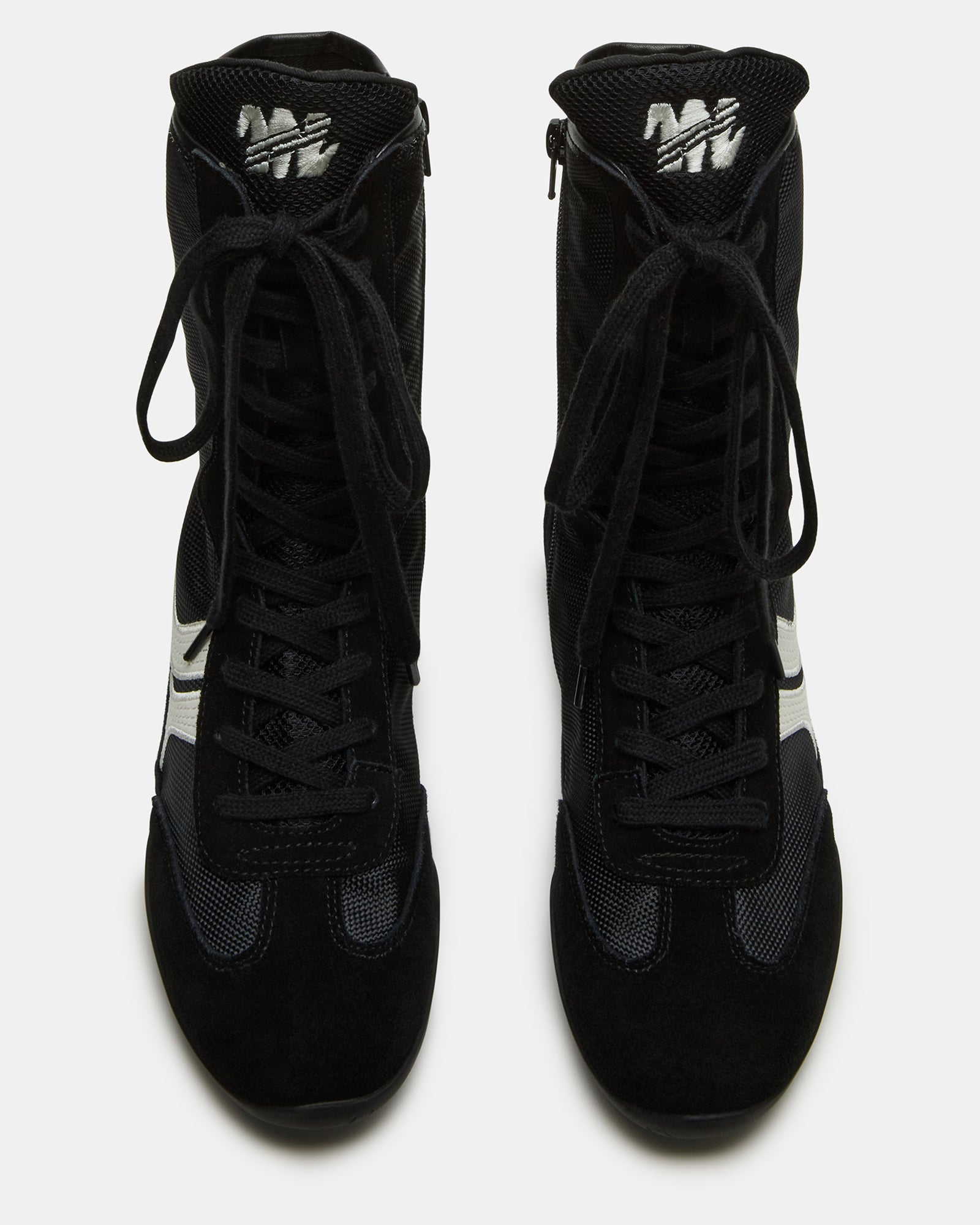 Top-down view of Paxtin black high top sneakers styled with cuffed jeans