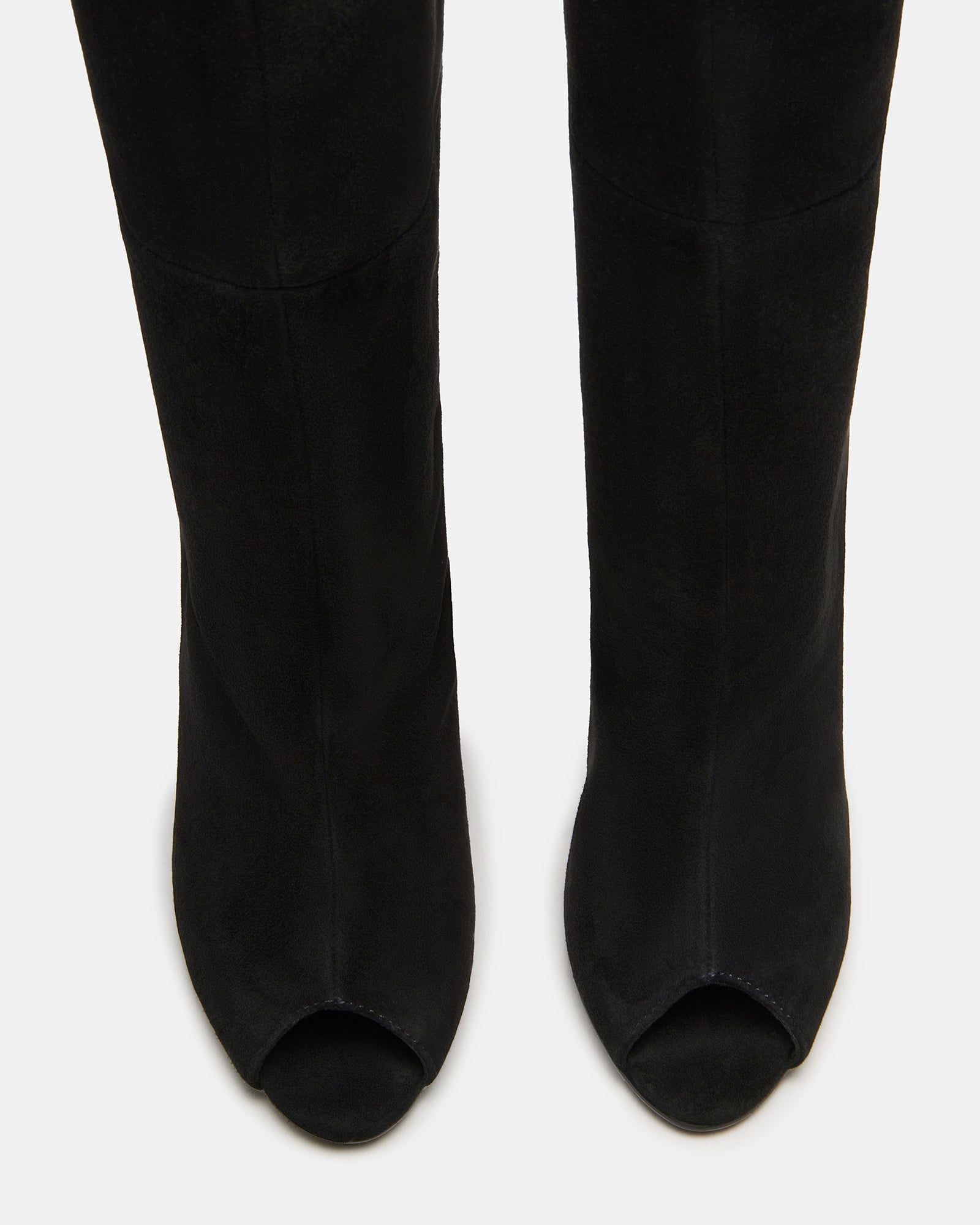Black suede knee-high boots from PEGGIE, showcasing stiletto heels