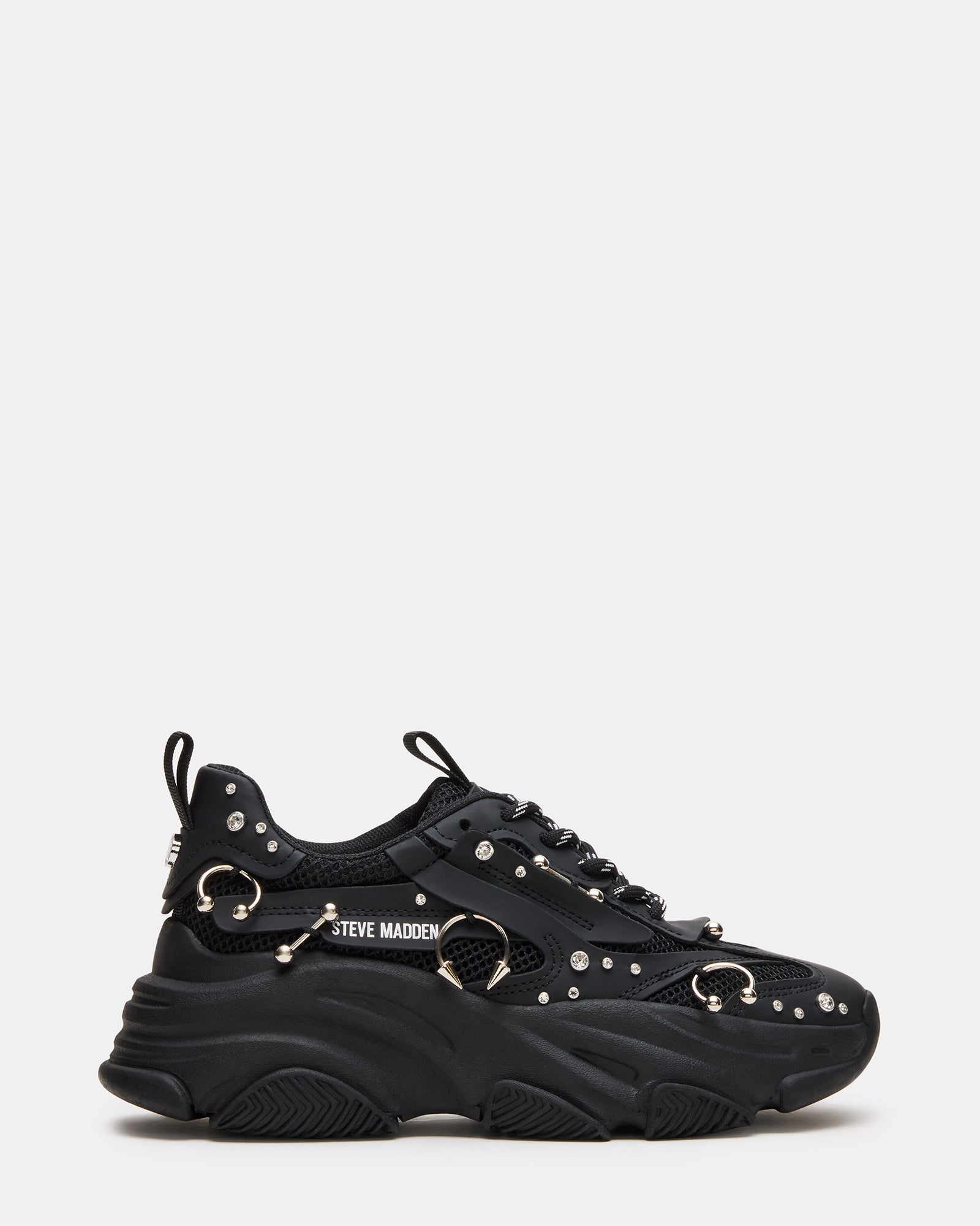 Close-up side angle of black fashion sneakers on concrete city steps