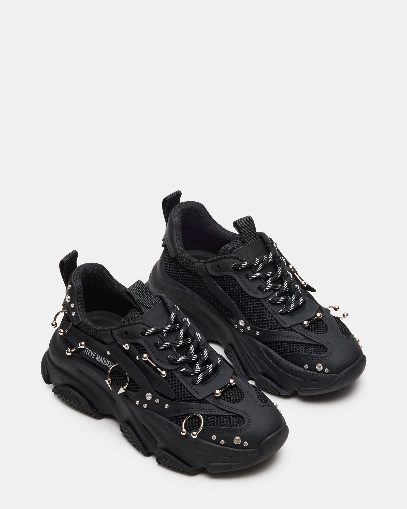 Top-down view of comfortable work sneakers for men styled with business-casual trousers