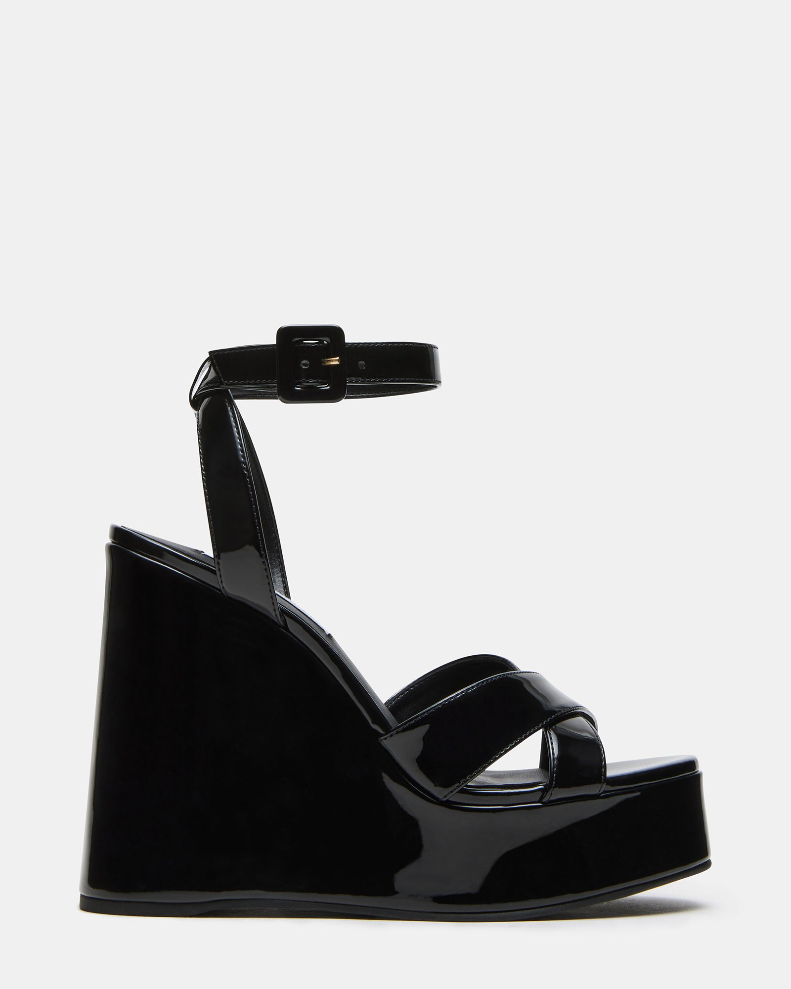 Side view of Pinnacle black patent platform wedge sandals highlighting the heel and ankle strap