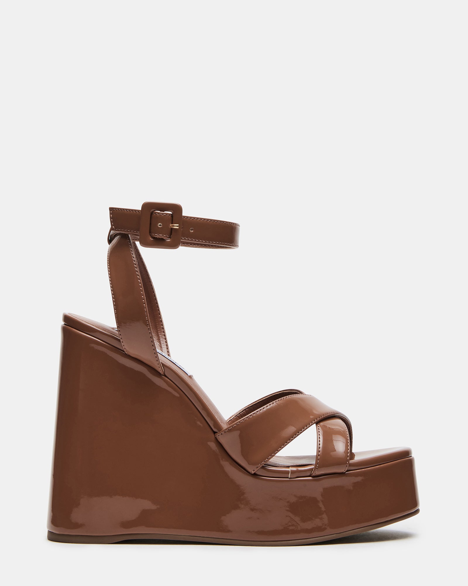 Front view of white platform sandals showing crisscross ankle straps