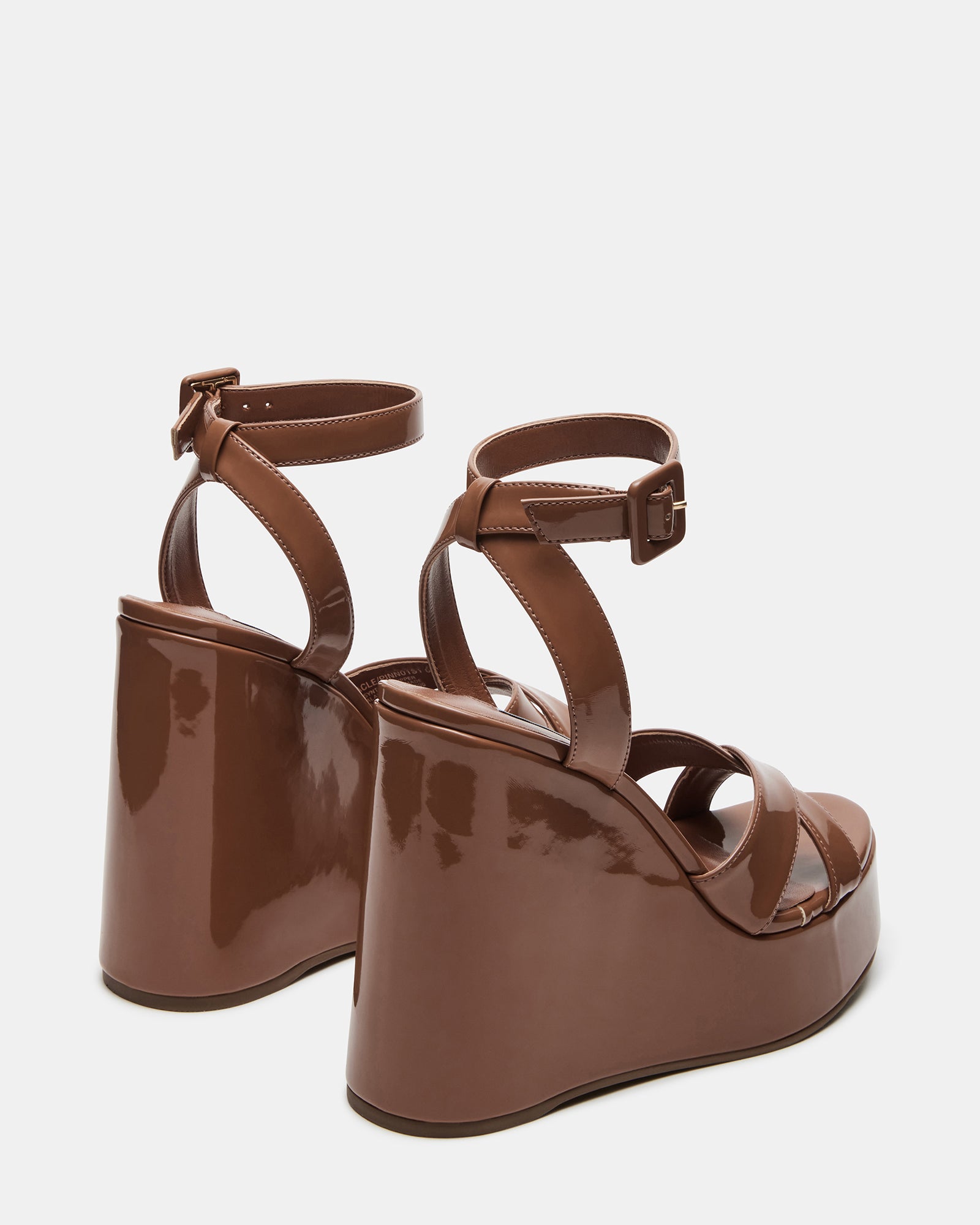 Black platform sandals on pavement demonstrating walkability