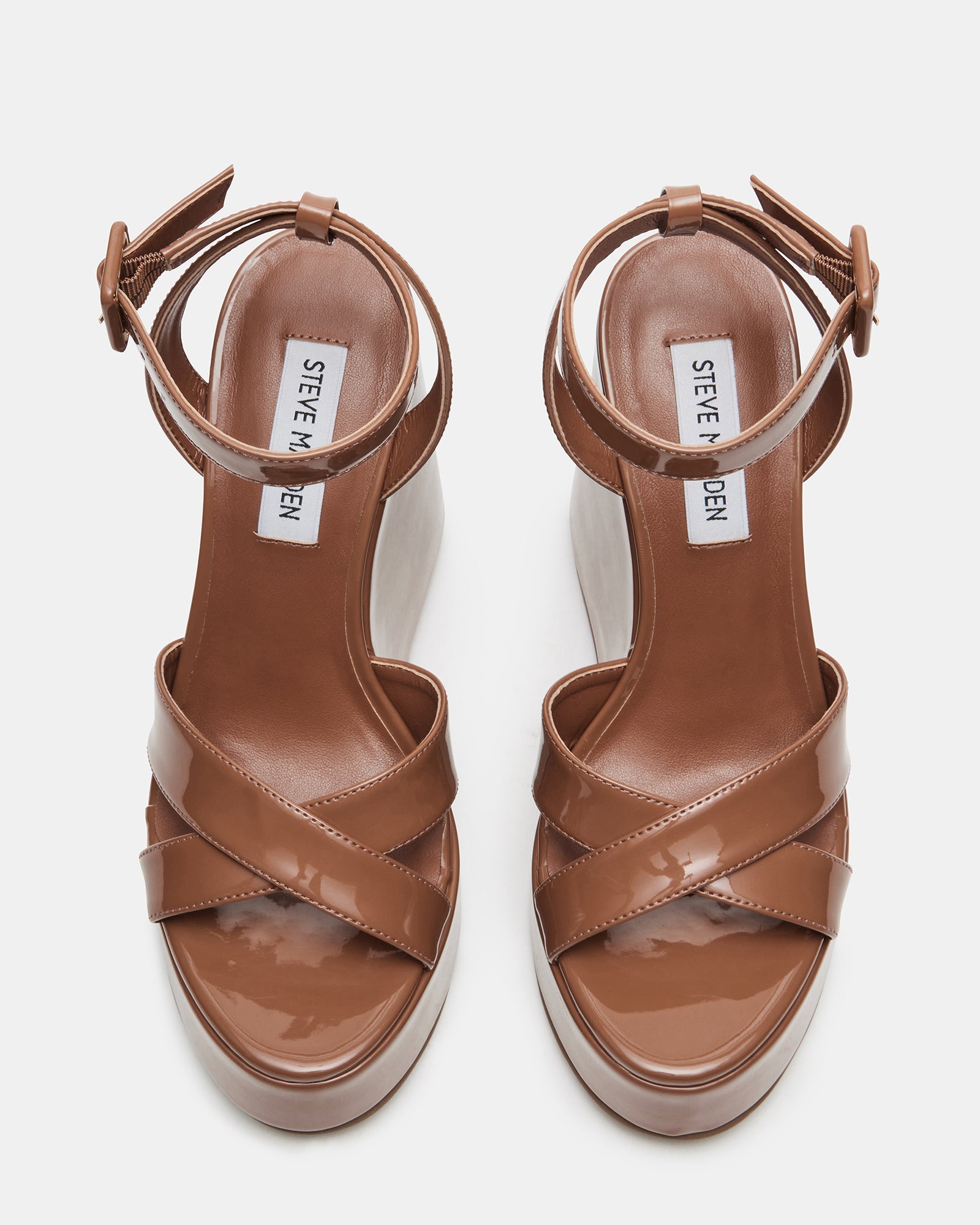 Front view of white platform sandals showing crisscross ankle straps