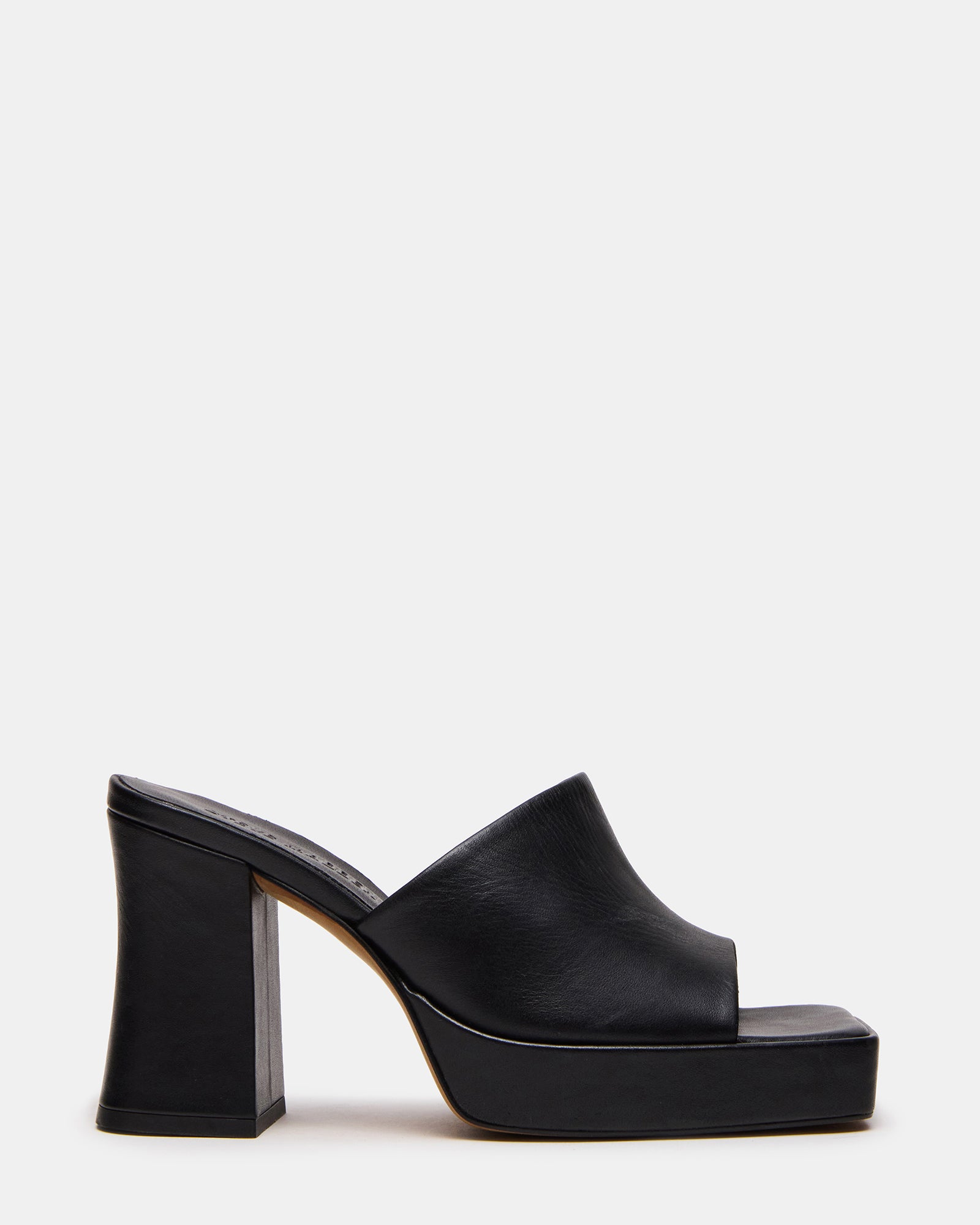 Black leather mule with square toe and block heel on a stylish woman