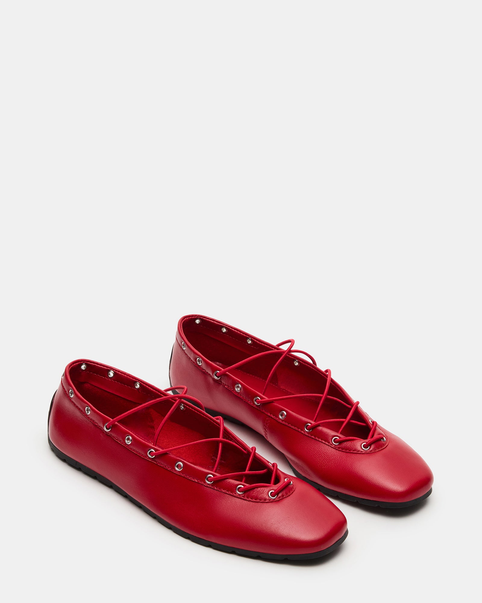 Close-up of the secure ankle ties on red leather ballerina shoes
