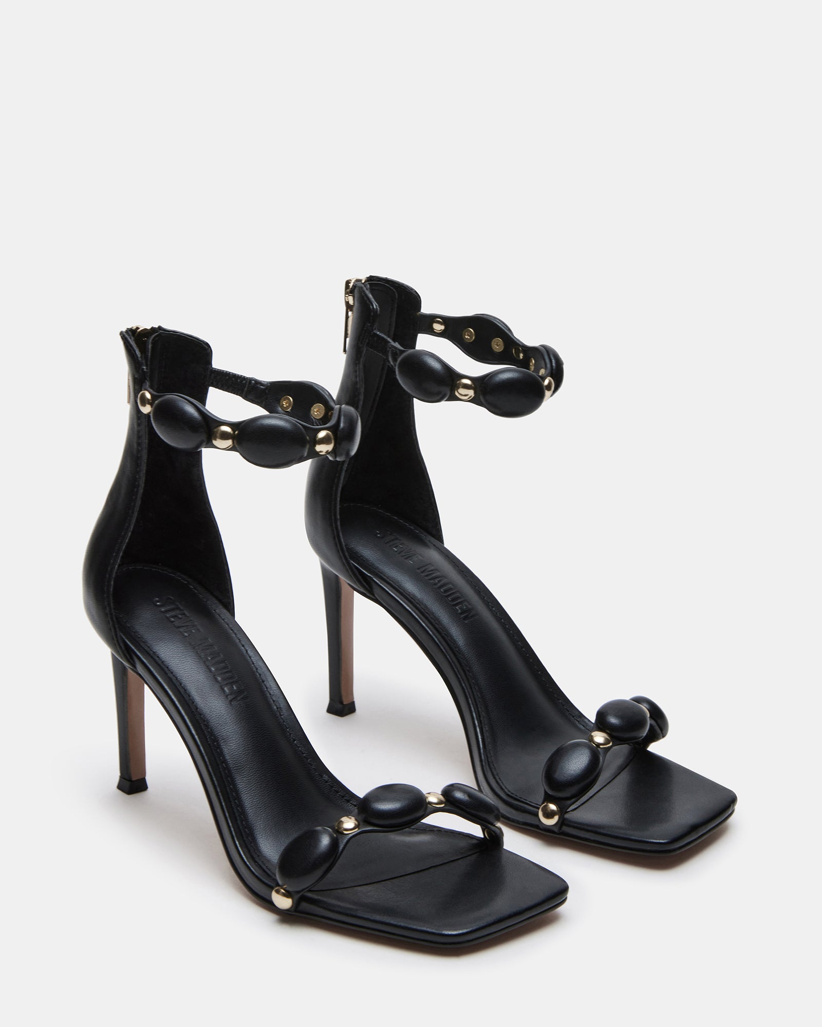 Close-up of POISE black high heels showcasing the synthetic upper