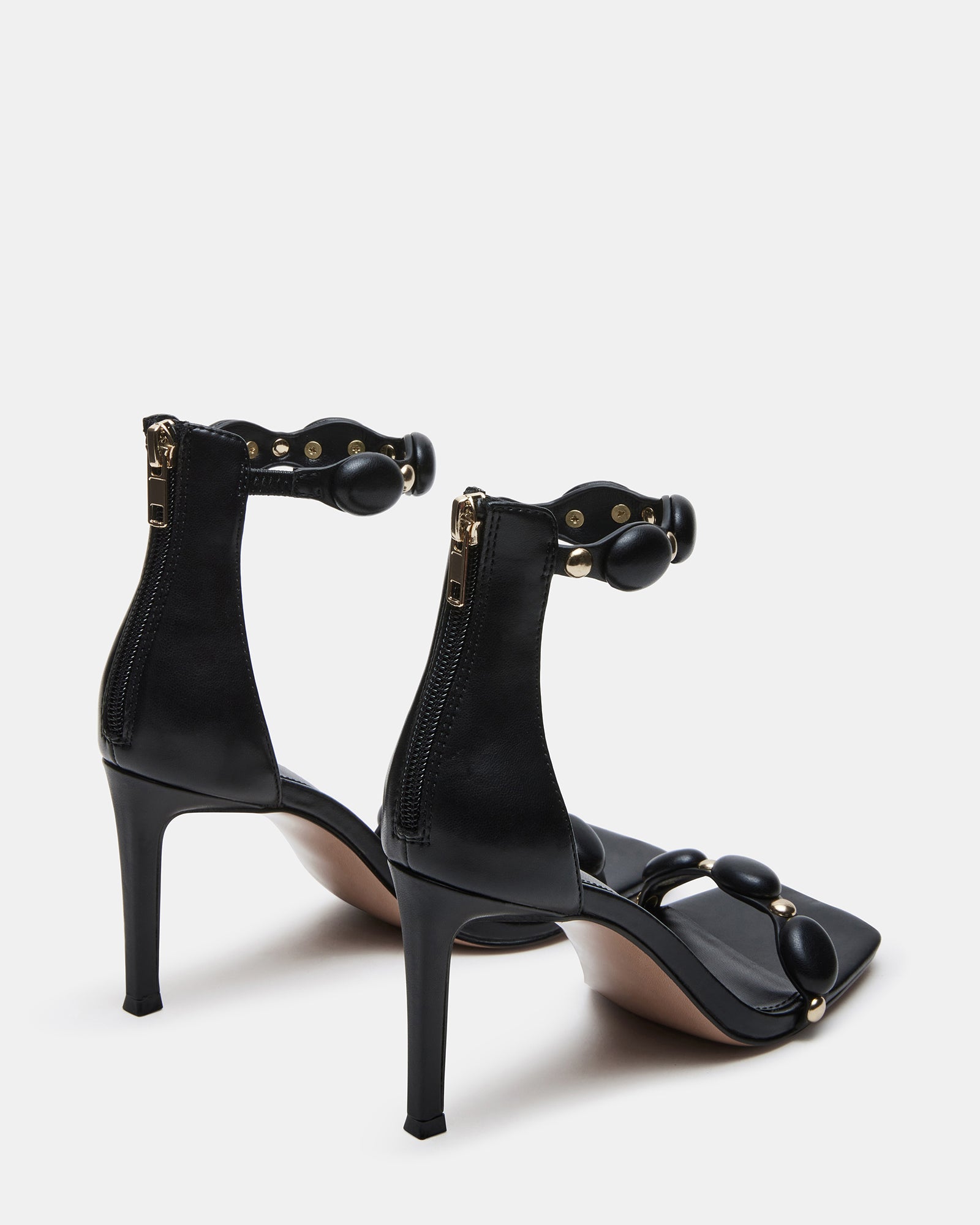 Close-up of POISE black high heels showcasing the synthetic upper