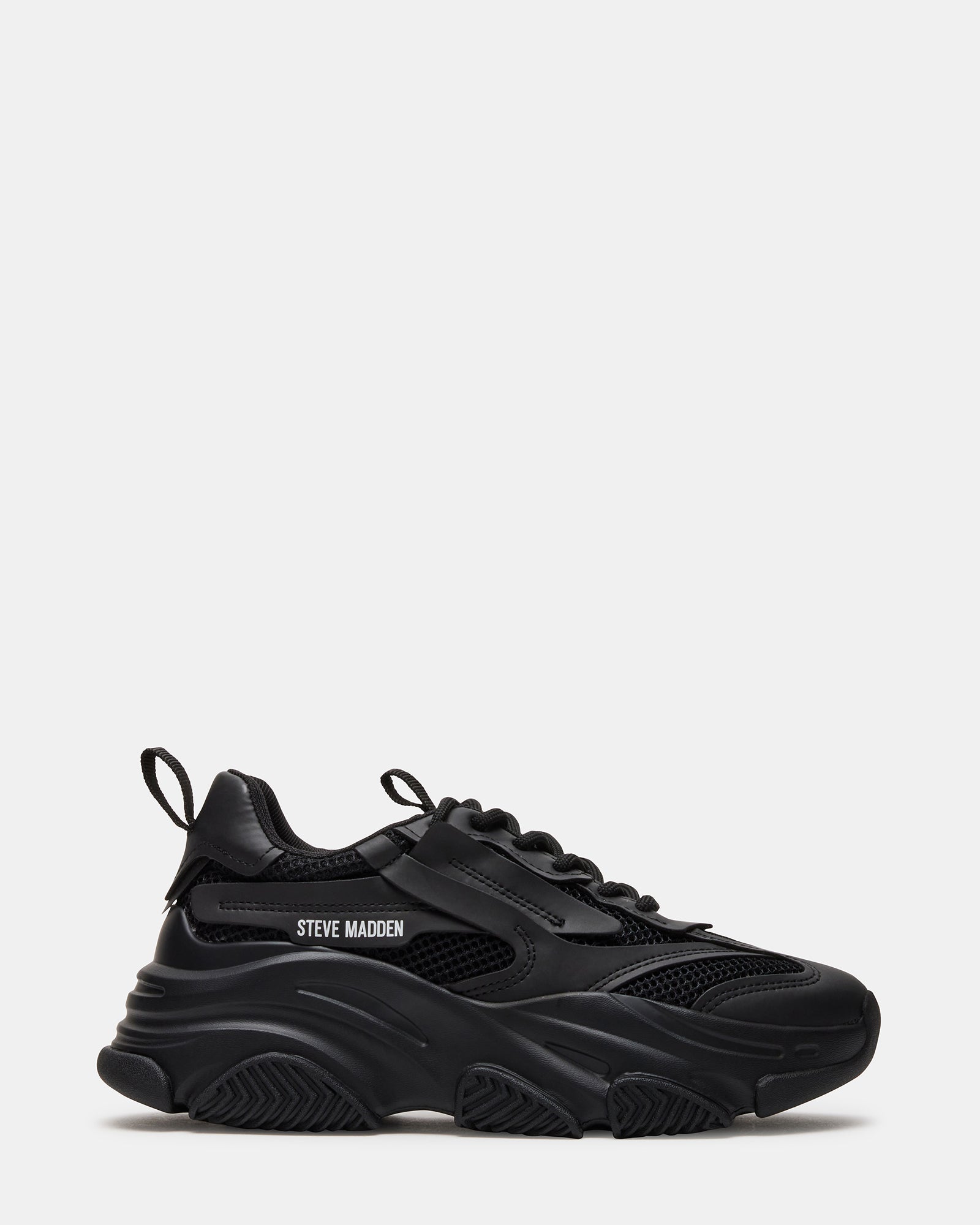 Side profile of black dad sneakers showing thick sole and textile detailing