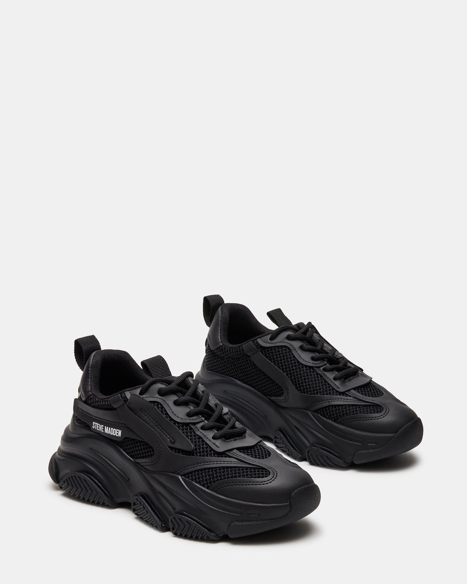 Outdoor shot of black sneakers styled for city weekend walk