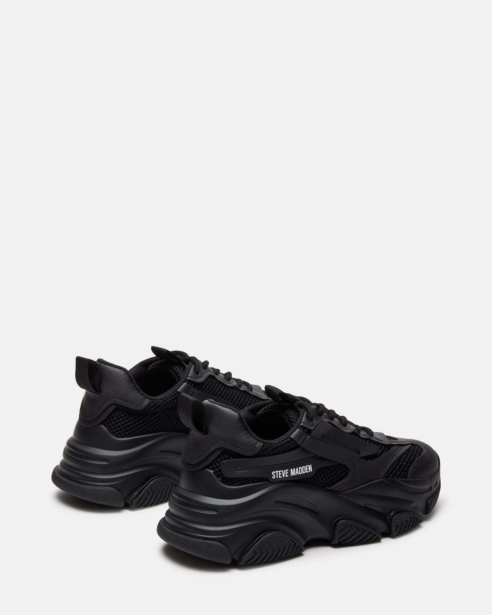 Outdoor shot of black sneakers styled for city weekend walk