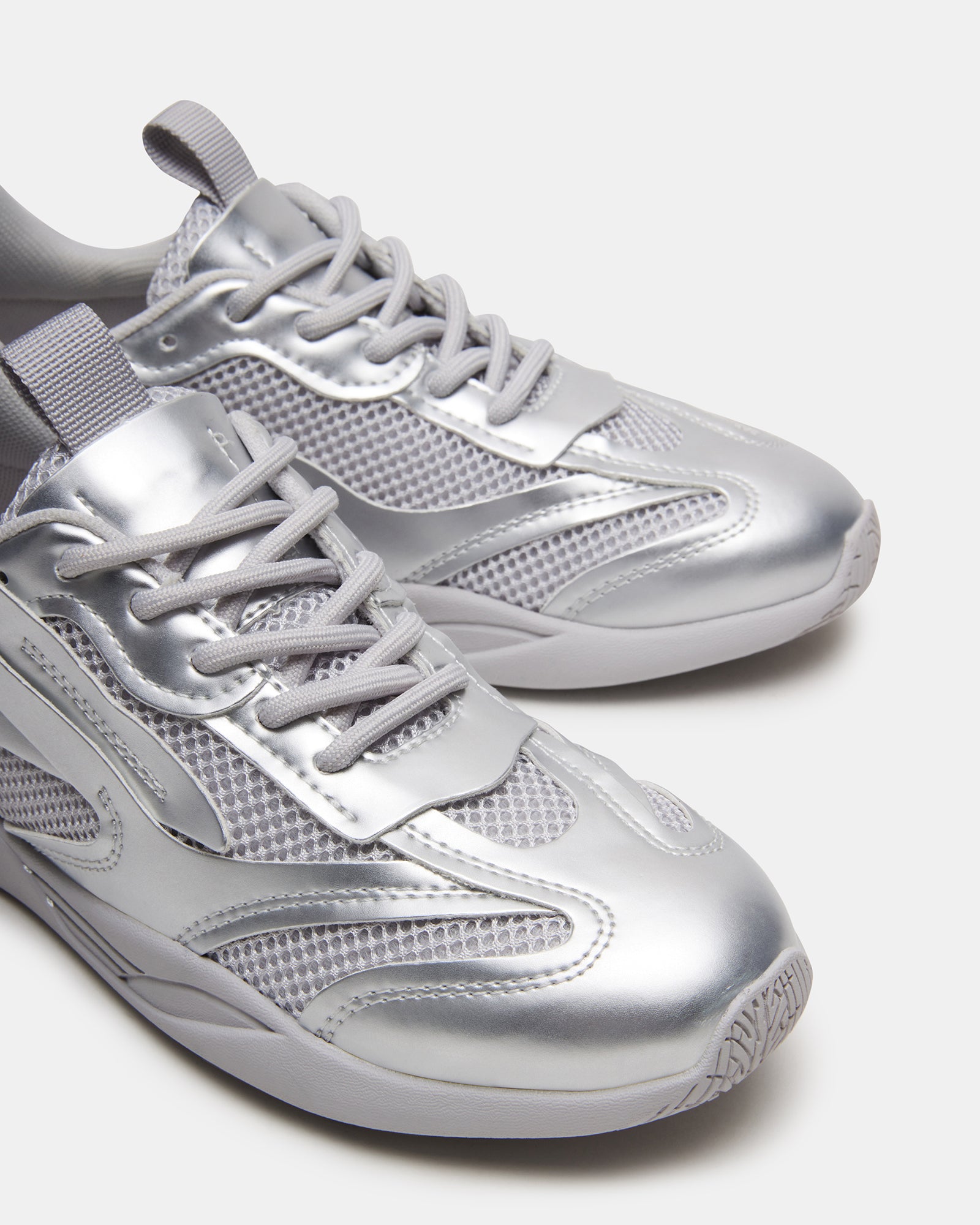 Detail shot of the lace-up closure and textured sole of Pounce Silver sneakers