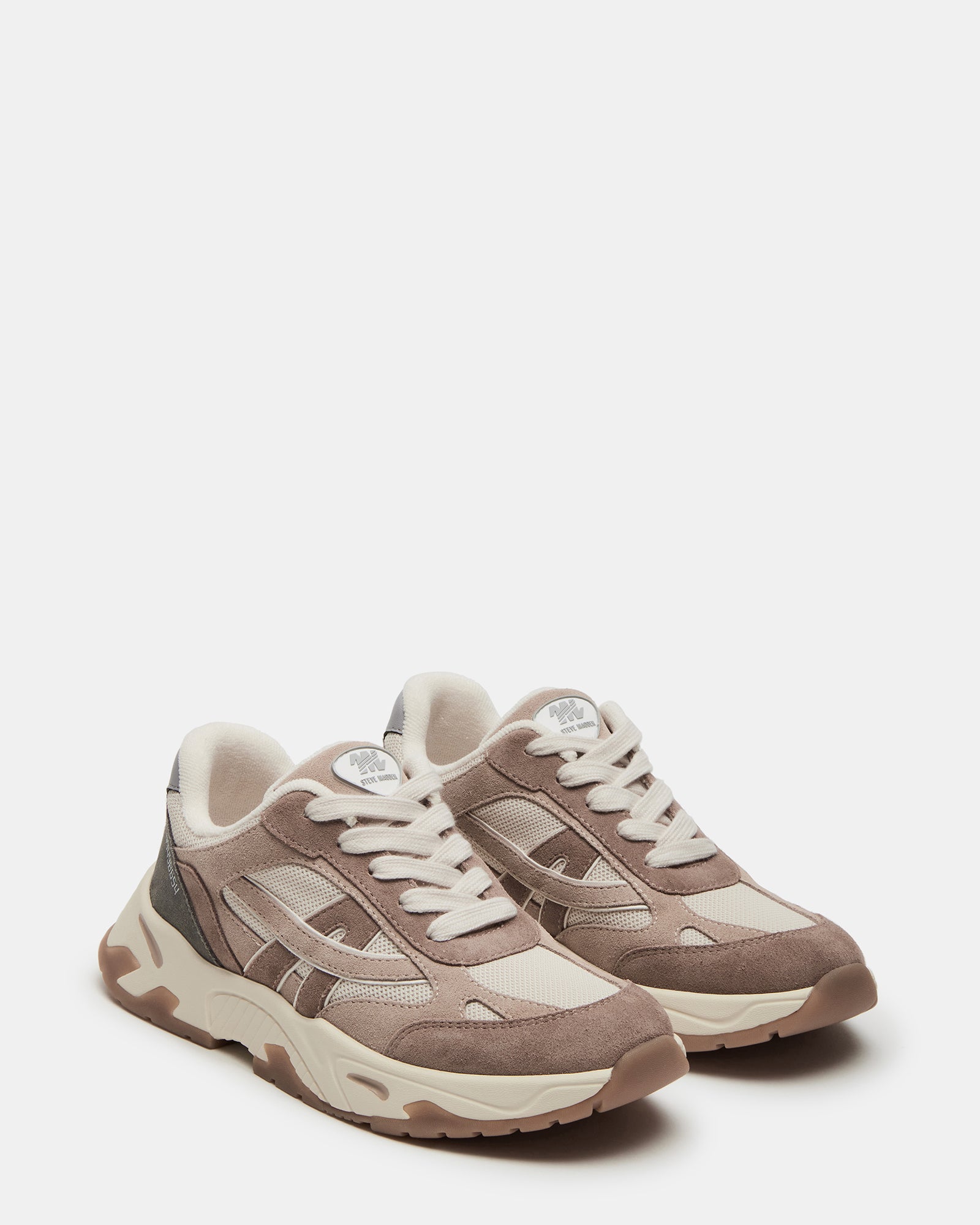 Top view of white sneakers with textile and suede material