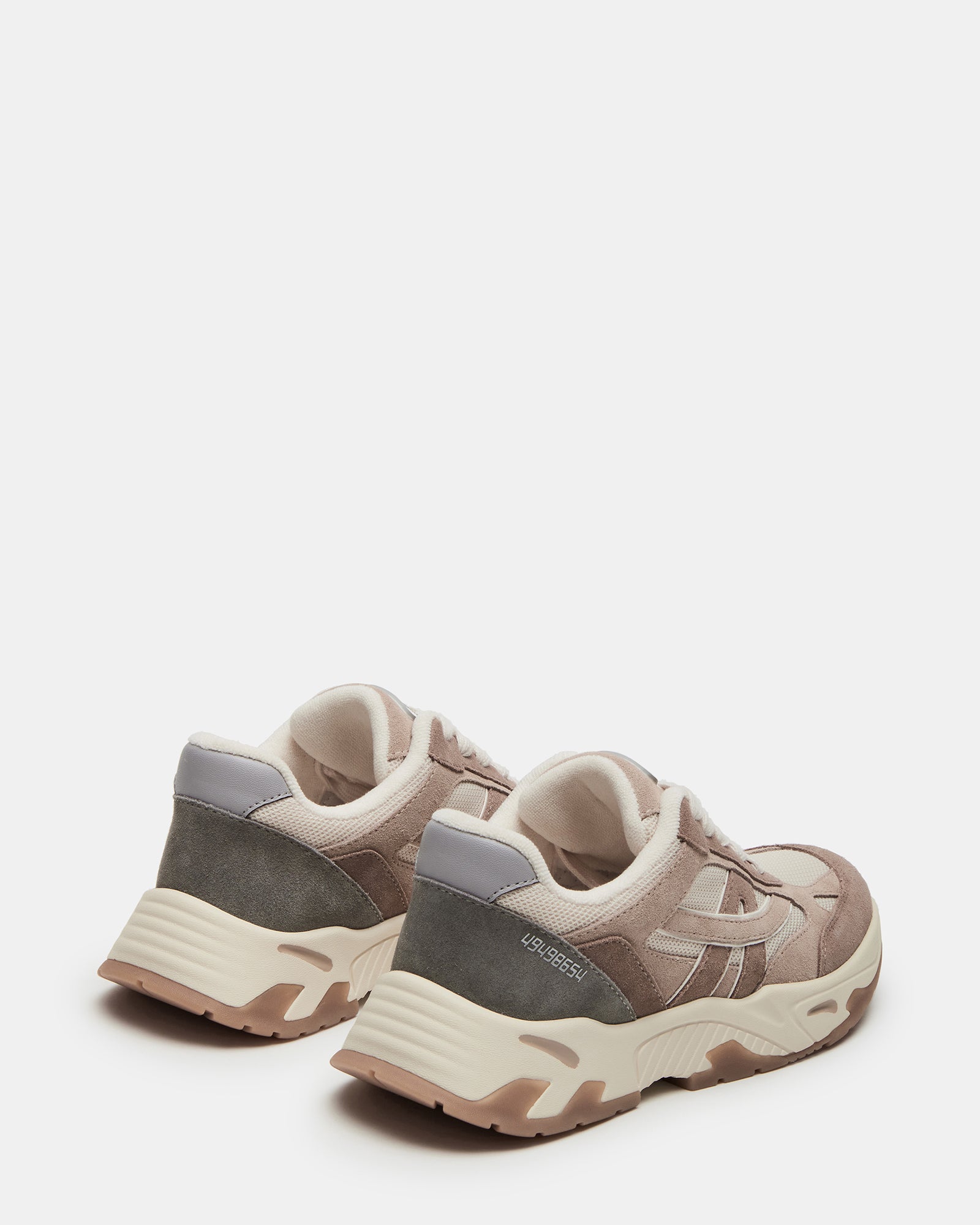 Top view of white sneakers with textile and suede material