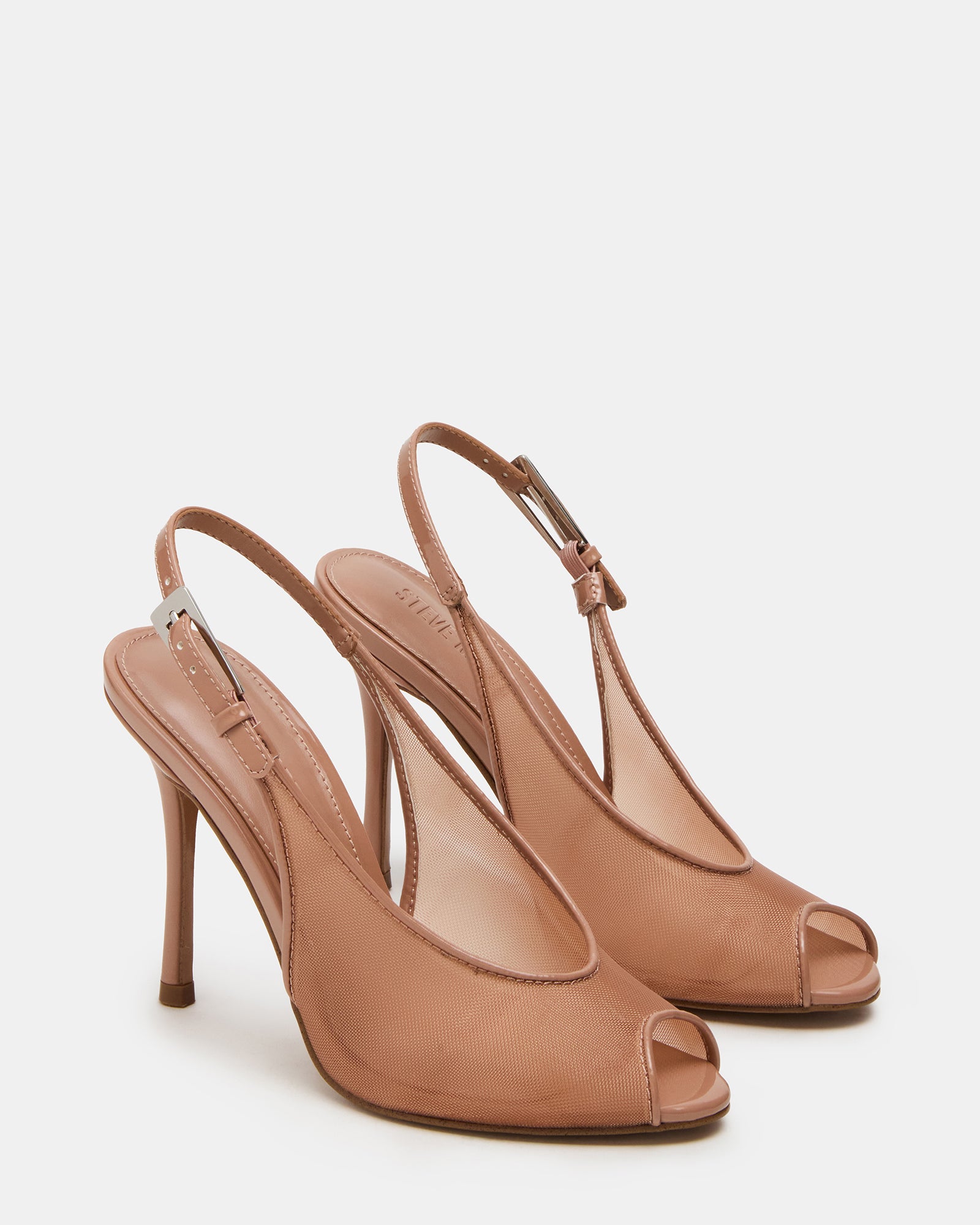 Close-up of silver slingback heels styled with evening wear for date night