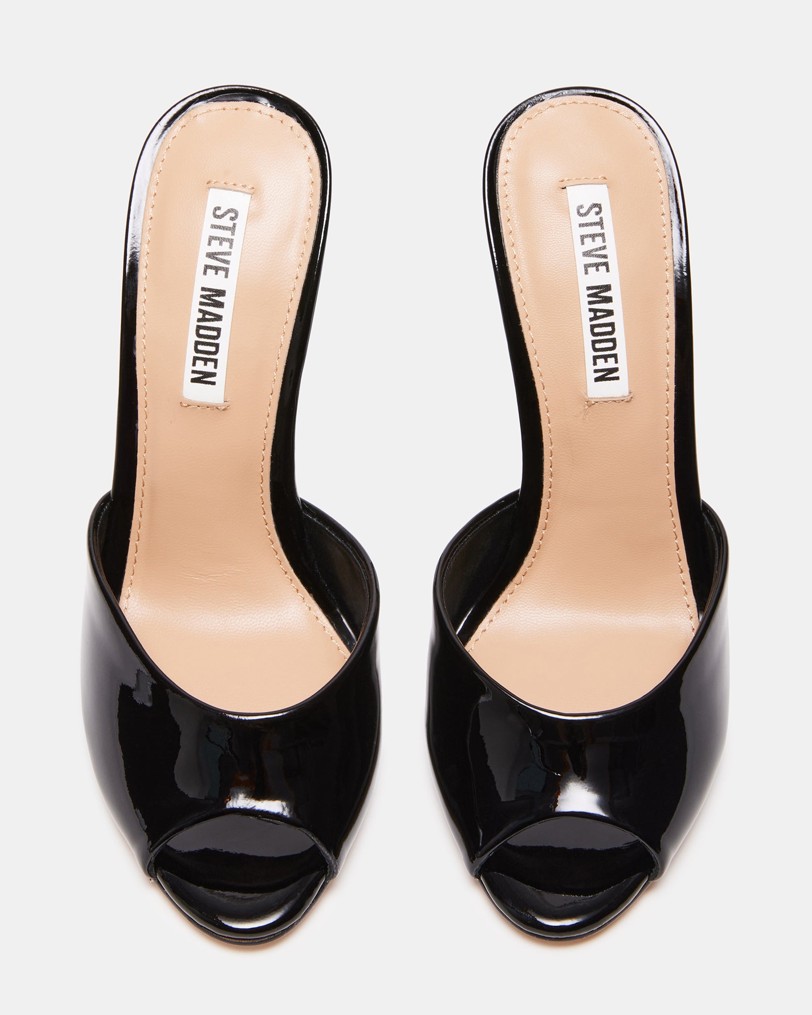 Priya black patent leather sandals worn with an elegant outfit for a night out.