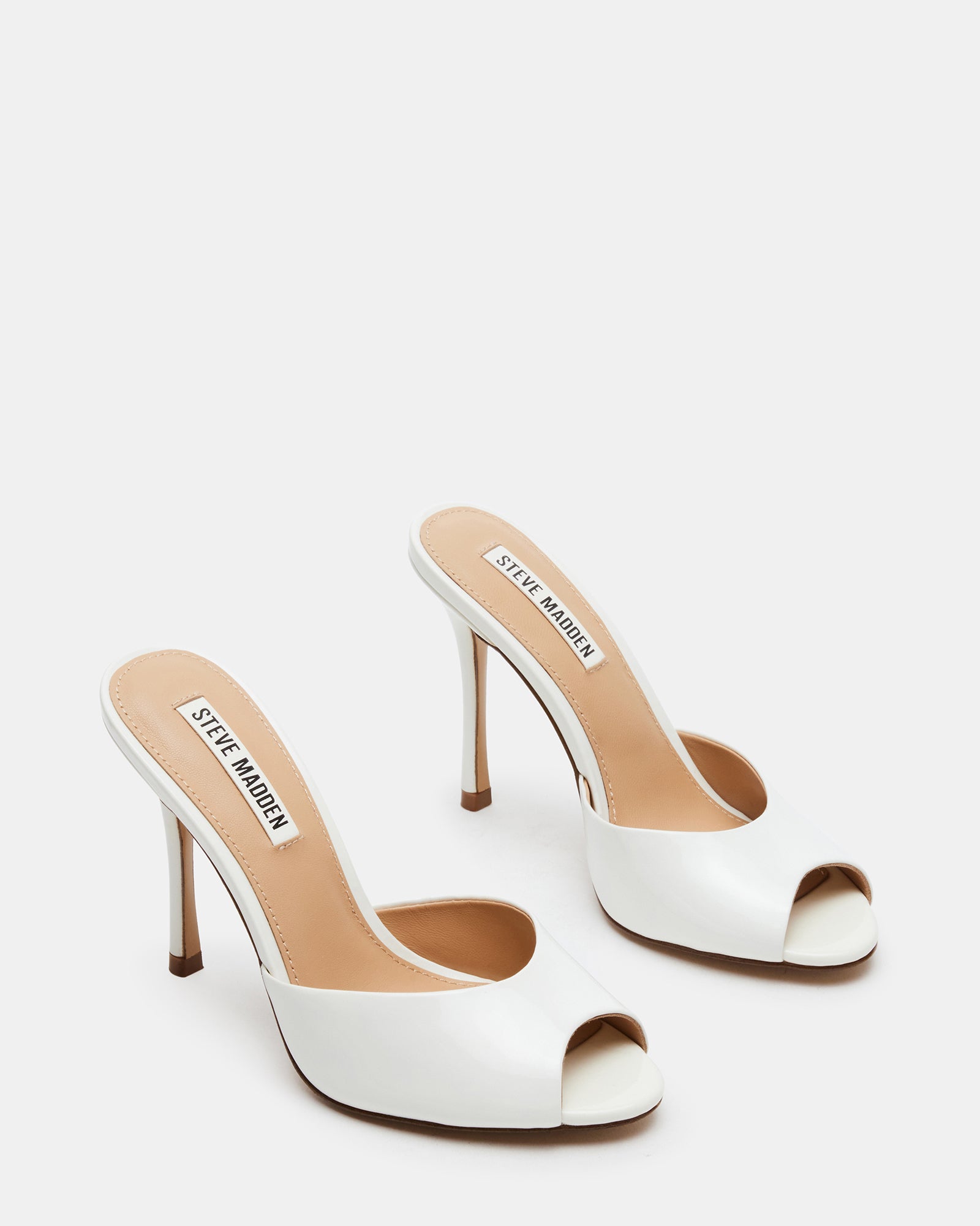 Lifestyle photo of black stiletto heels worn for a rooftop dinner setting