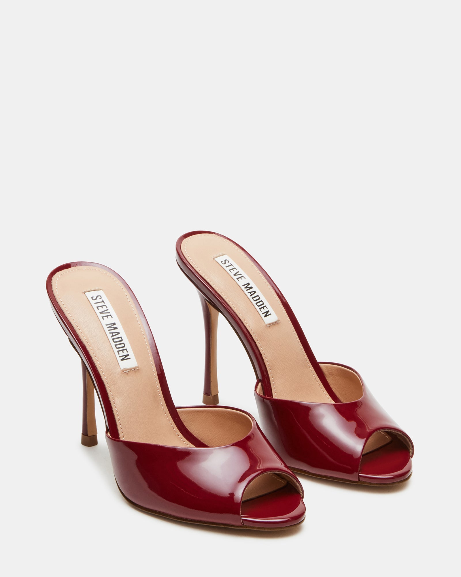 Worn pair of Priya Wine Patent heels styled with a chic evening outfit