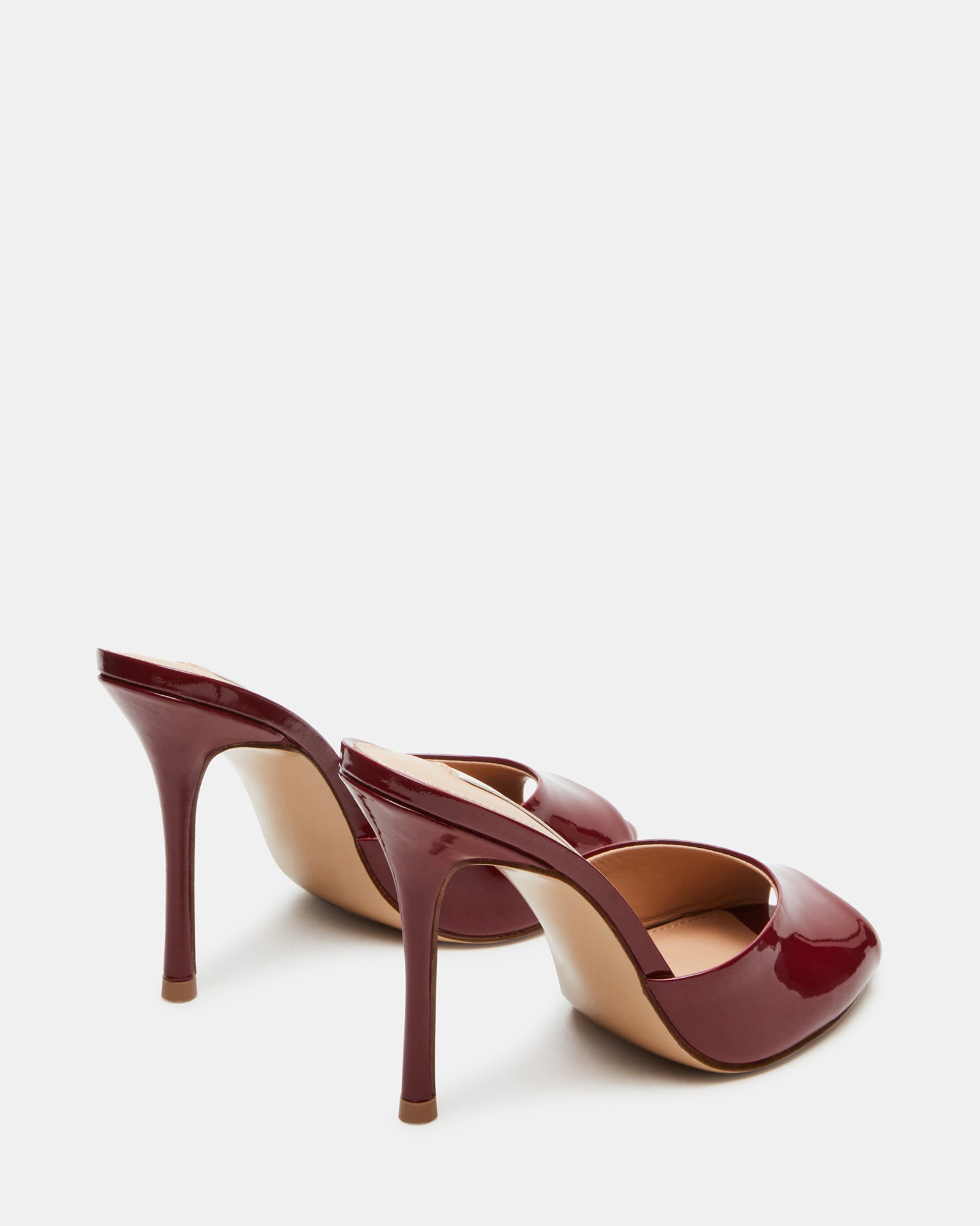 Worn pair of Priya Wine Patent heels styled with a chic evening outfit