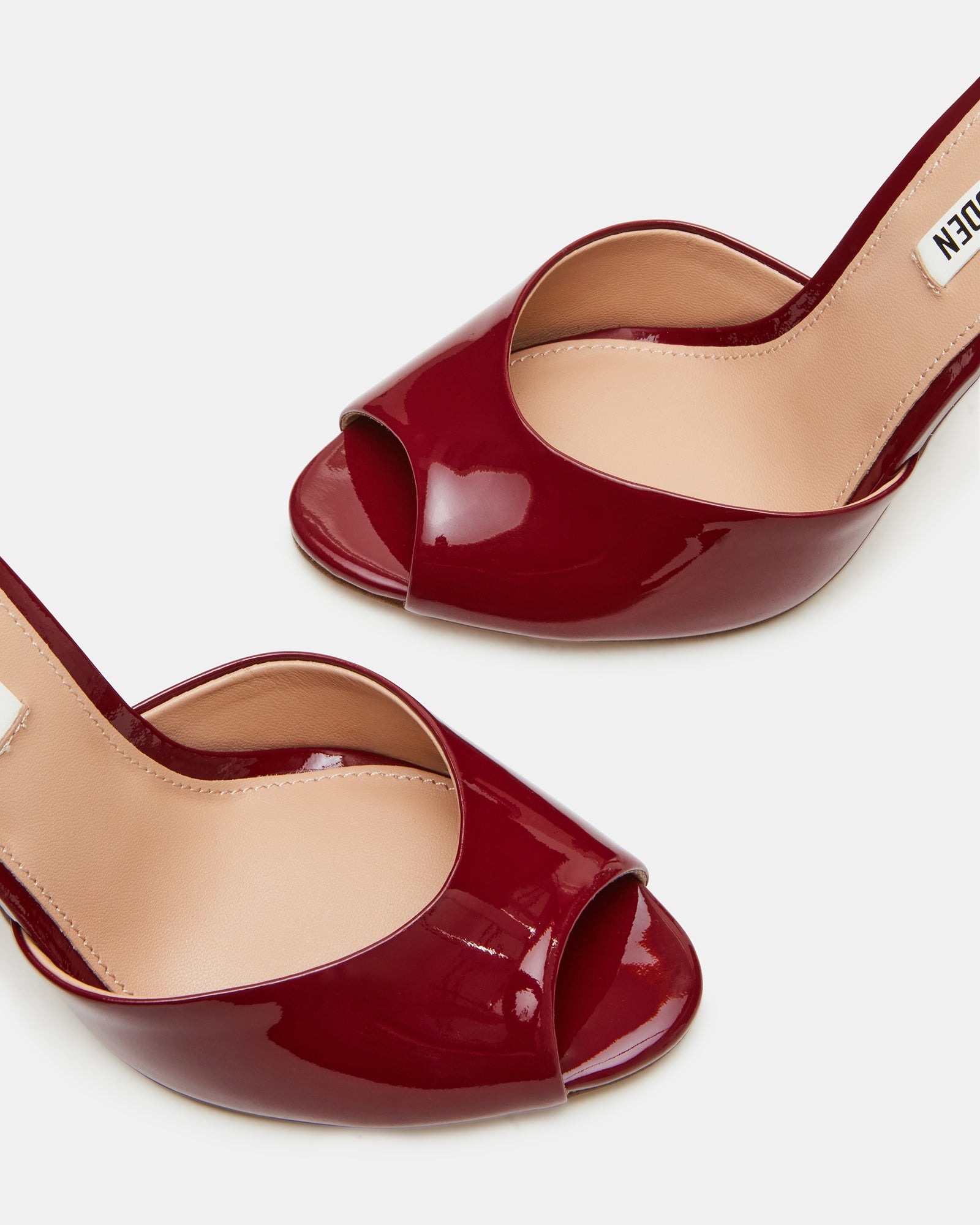 Side view of Priya Wine Patent peep toe stiletto sandals highlighting the retro design