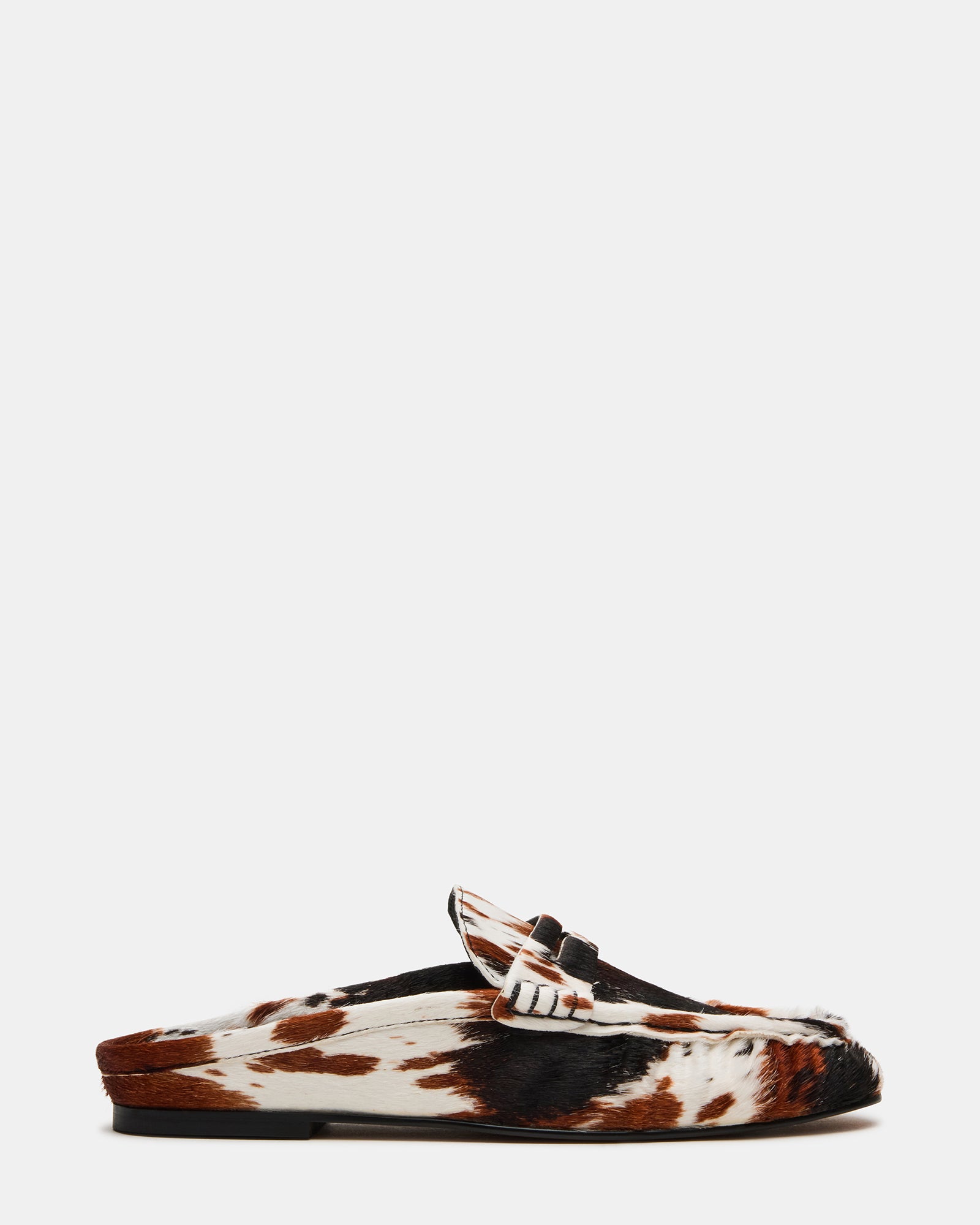 RAFE men's leather slip-on shoes in brown cow print, side view on urban sidewalk